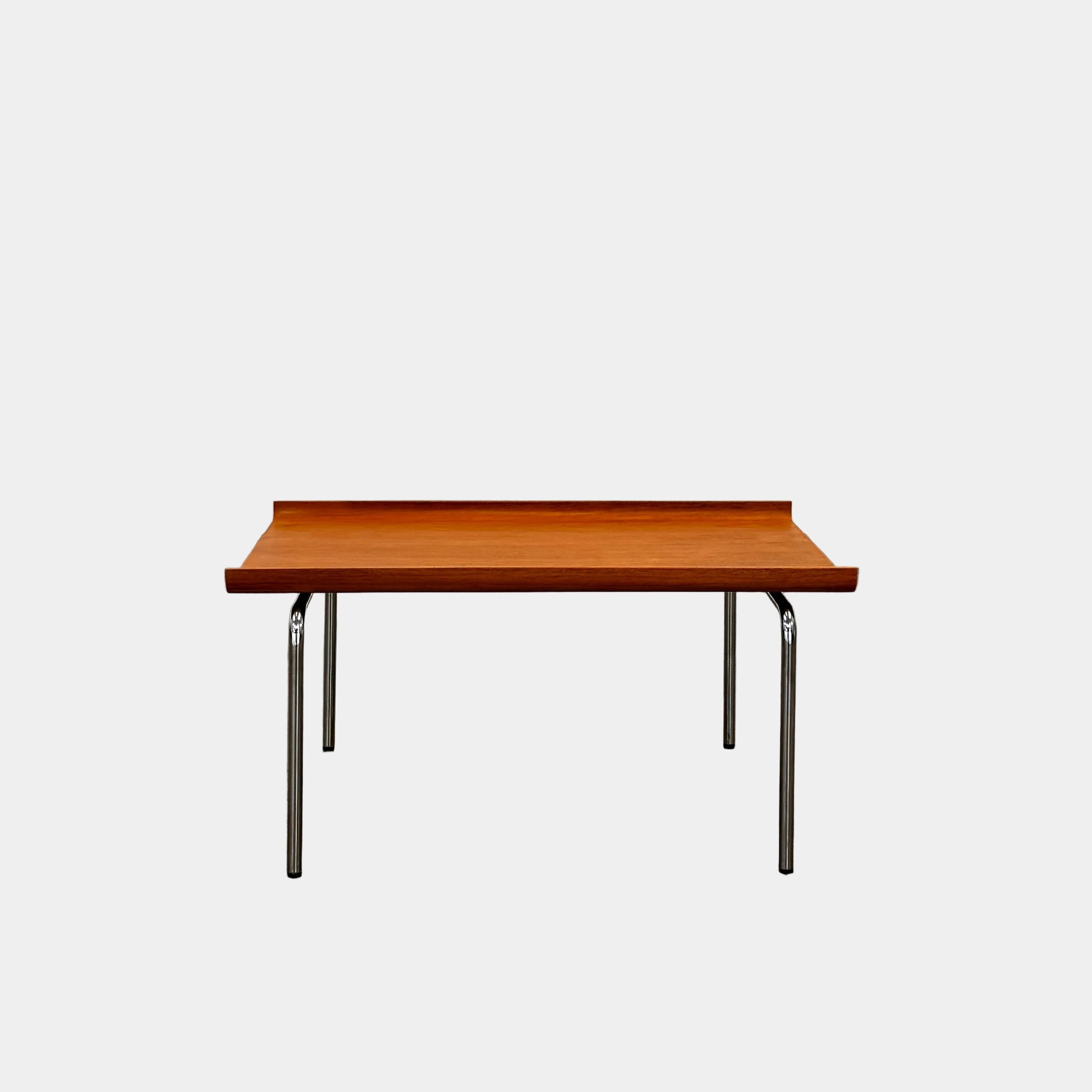 The Cappellini Side Table by Cappellini features stained beechwood, a raised back edge, and four chromed steel legs, shown against a plain white background.