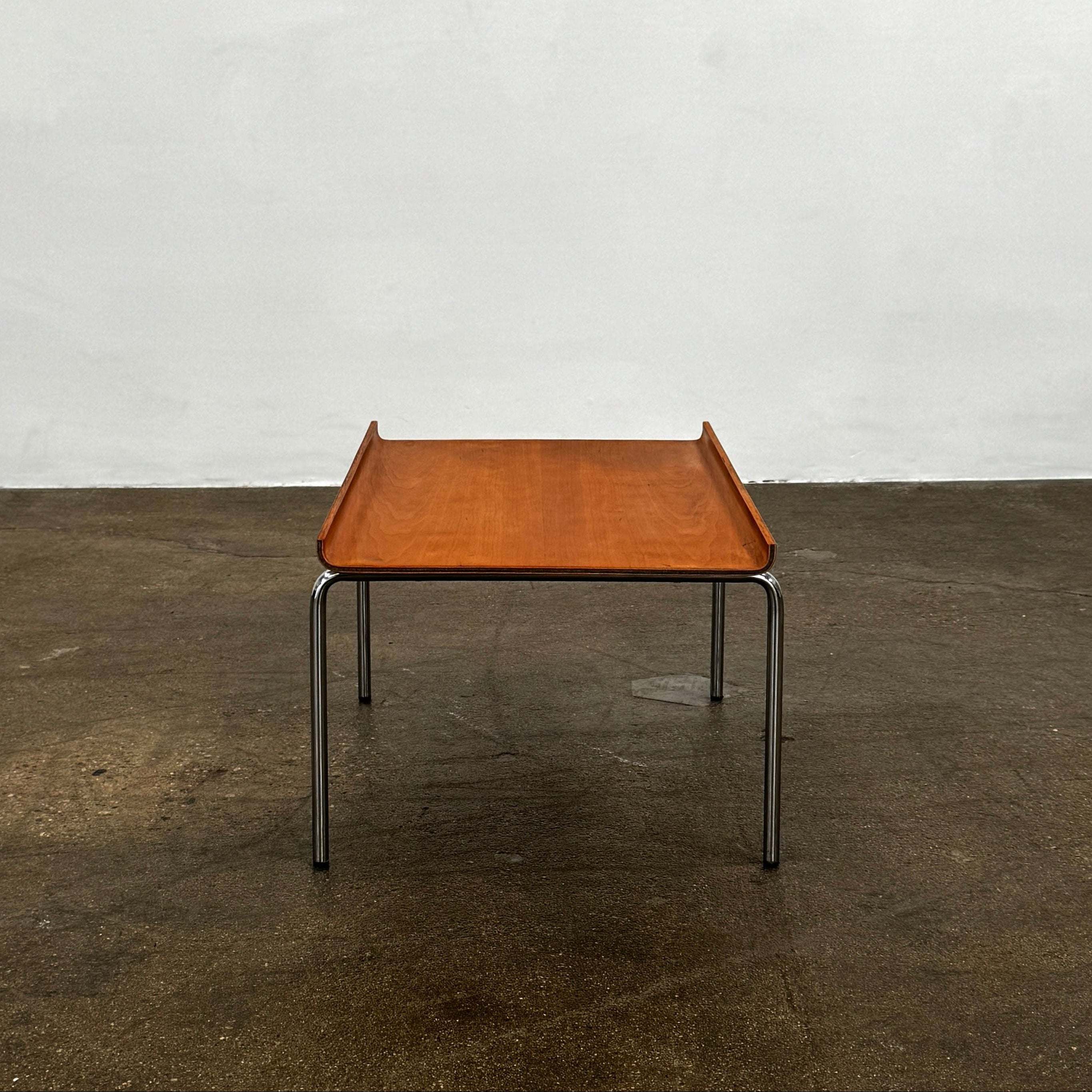 The Cappellini Side Table by Cappellini features stained beechwood, a raised back edge, and four chromed steel legs, shown against a plain white background.