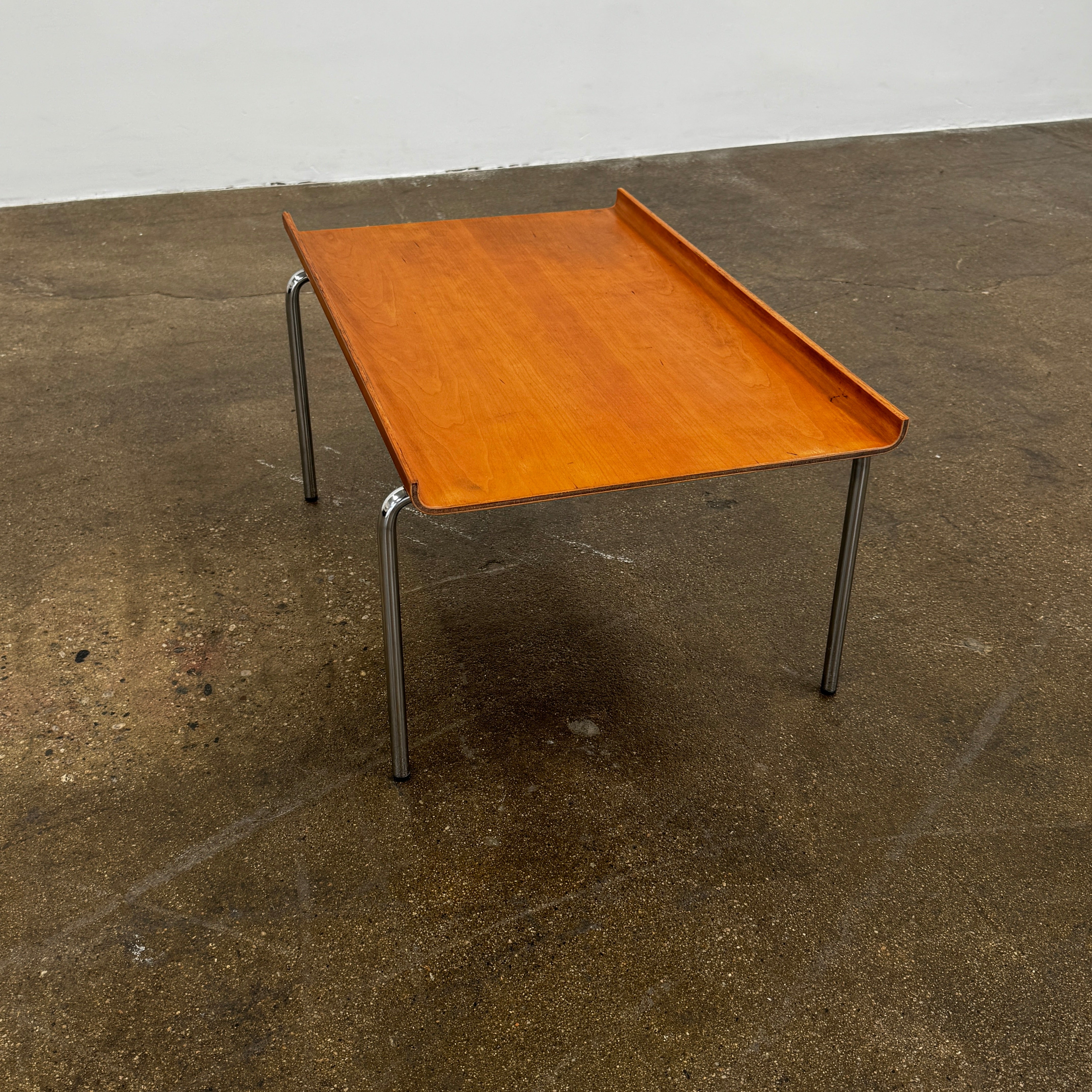 The Cappellini Side Table by Cappellini features stained beechwood, a raised back edge, and four chromed steel legs, shown against a plain white background.