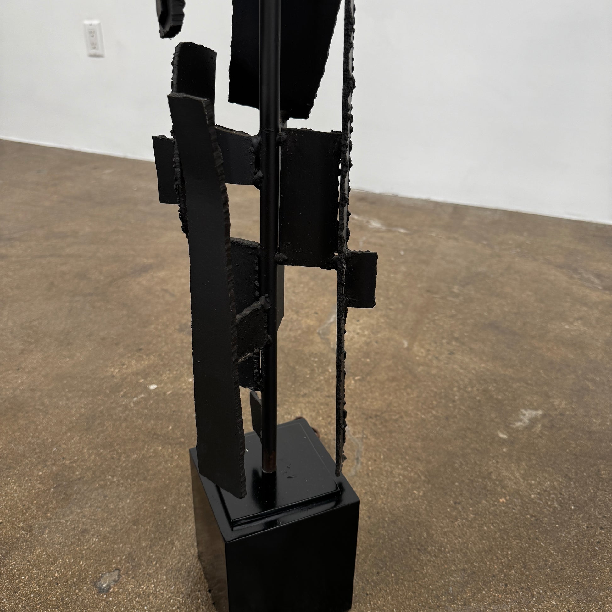 A pair of Vintage Richard Barr Iron Brutalist table lamps for Laurel Lamp Co., featuring abstract black metal bases and cylindrical white shades, set against a plain white background.