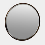 The Uttermost Round Mirror by Uttermost features a bronzed patina and hangs elegantly on the wall.