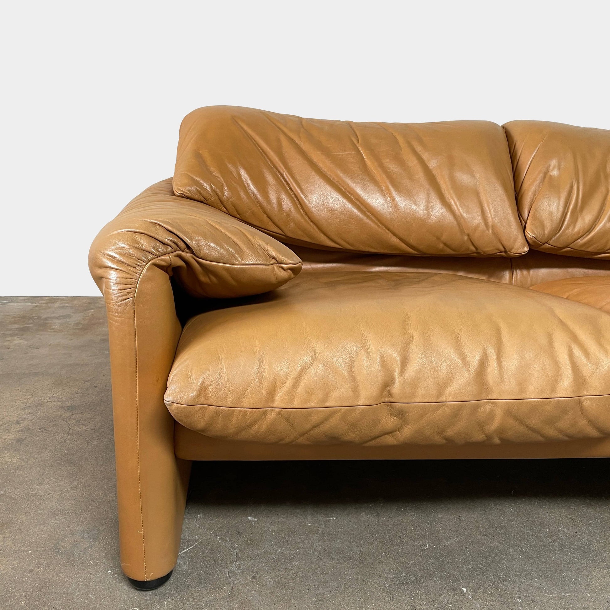 A Cassina Maralunga Two Seater sofa on a white background.