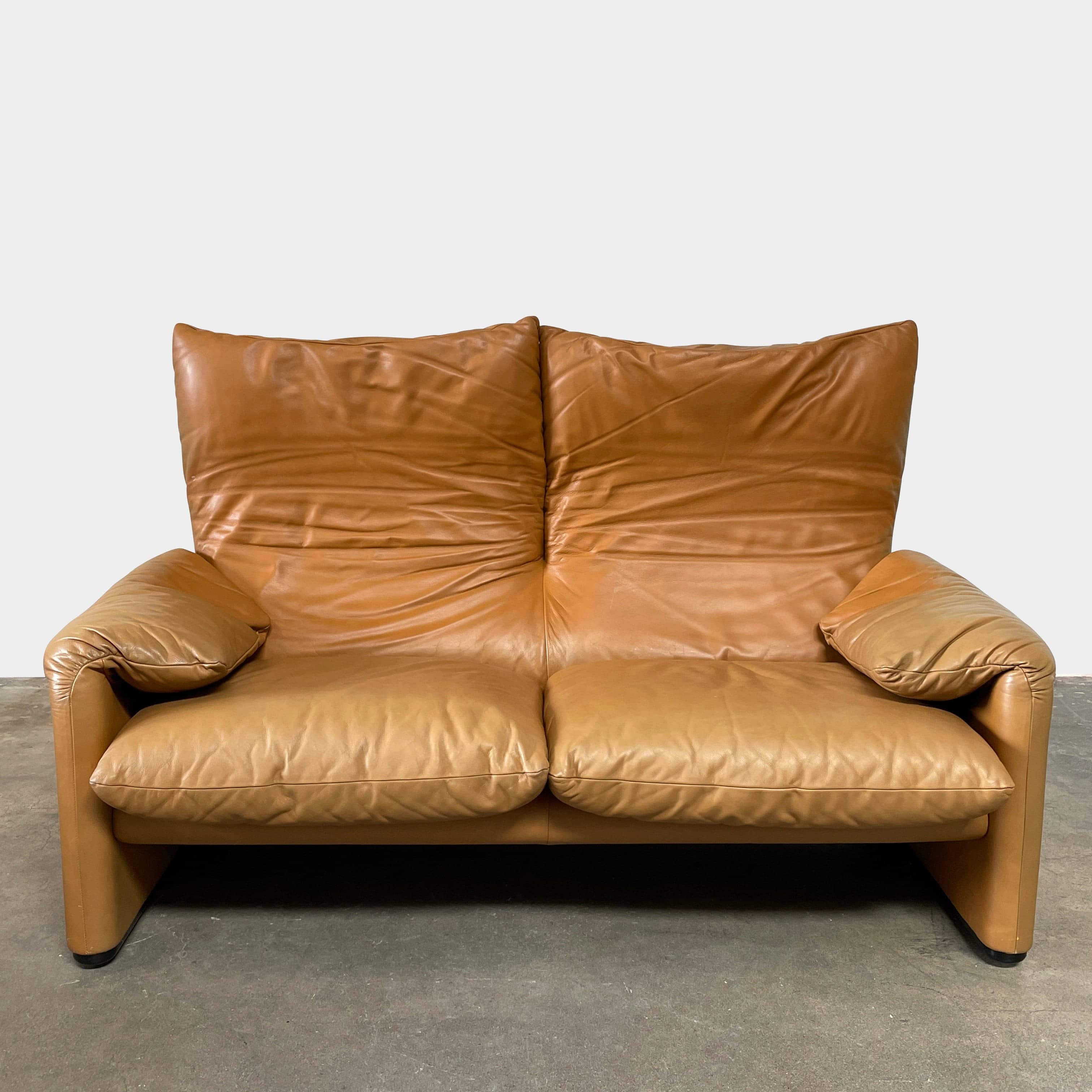 A Cassina Maralunga Two Seater sofa on a white background.