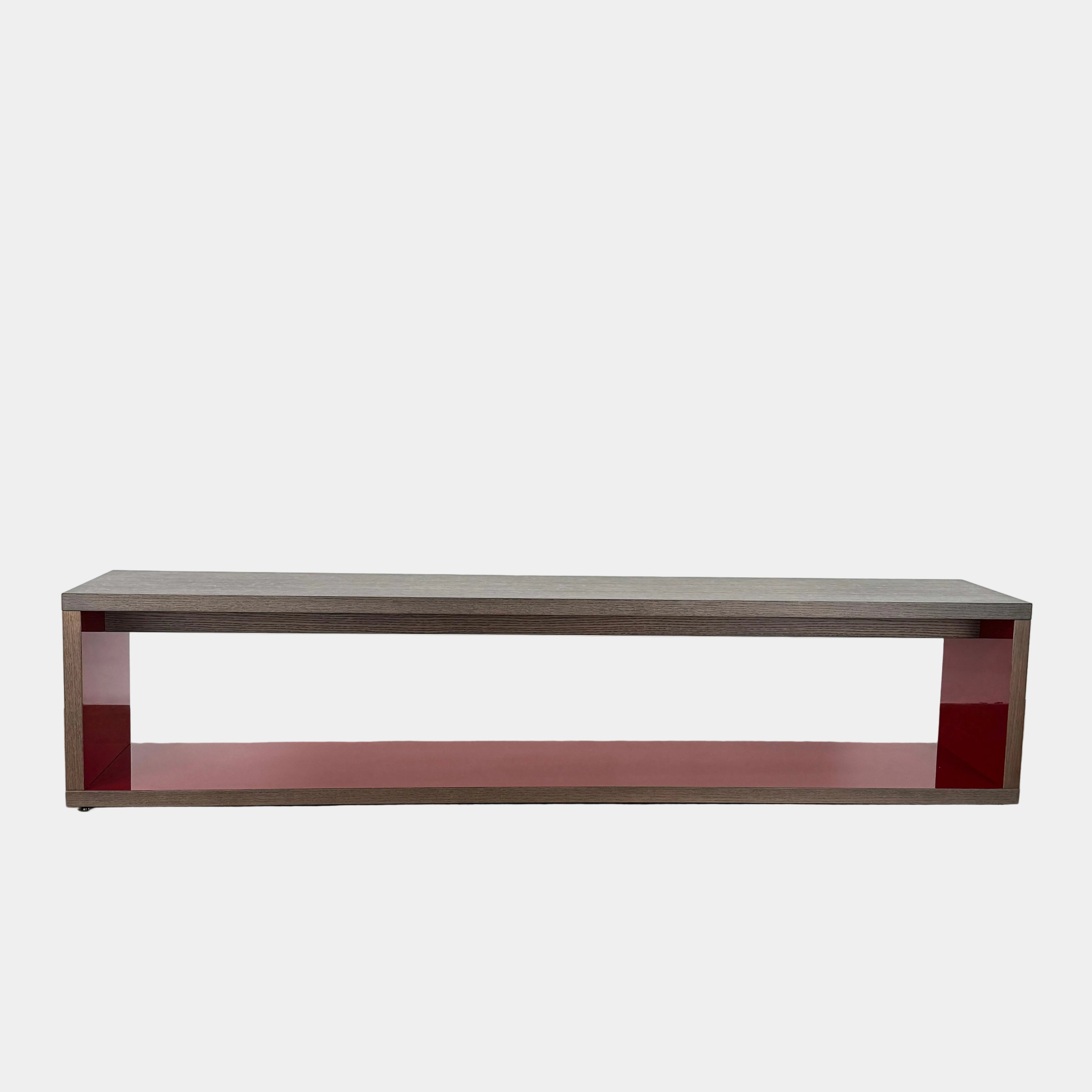 The B&B Italia Frank Low Console Table by B&B Italia features a rectangular, low-profile design with an open base and red interior shelf, shown against a plain white background.