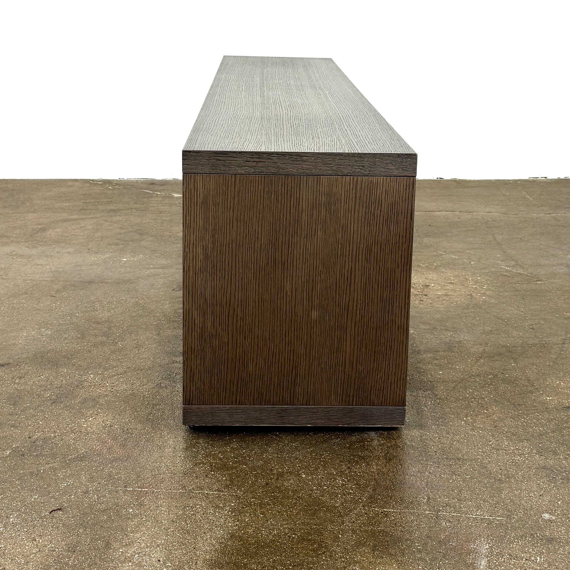 The B&B Italia Frank Low Console Table by B&B Italia features a rectangular, low-profile design with an open base and red interior shelf, shown against a plain white background.