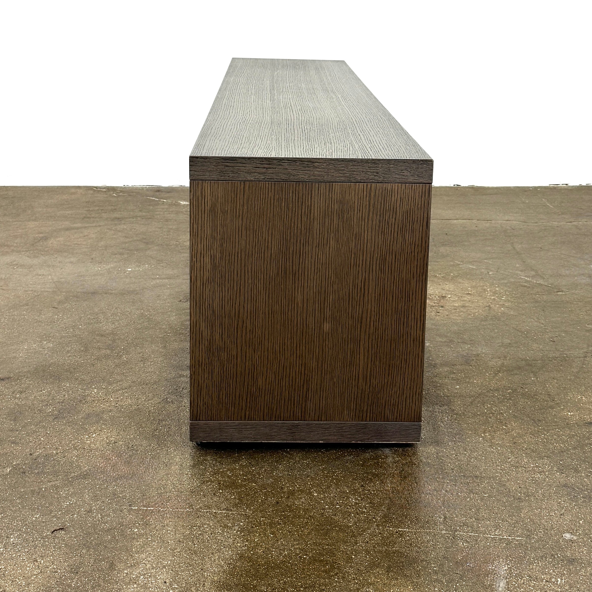 The B&B Italia Frank Low Console Table by B&B Italia features a rectangular, low-profile design with an open base and red interior shelf, shown against a plain white background.