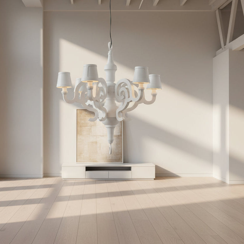 A white Moooi Paper Chandelier by Modern Resale with six arms and lampshades hangs from the ceiling on a black cord, serving as a striking 6 Light Chandelier centerpiece against a plain background.