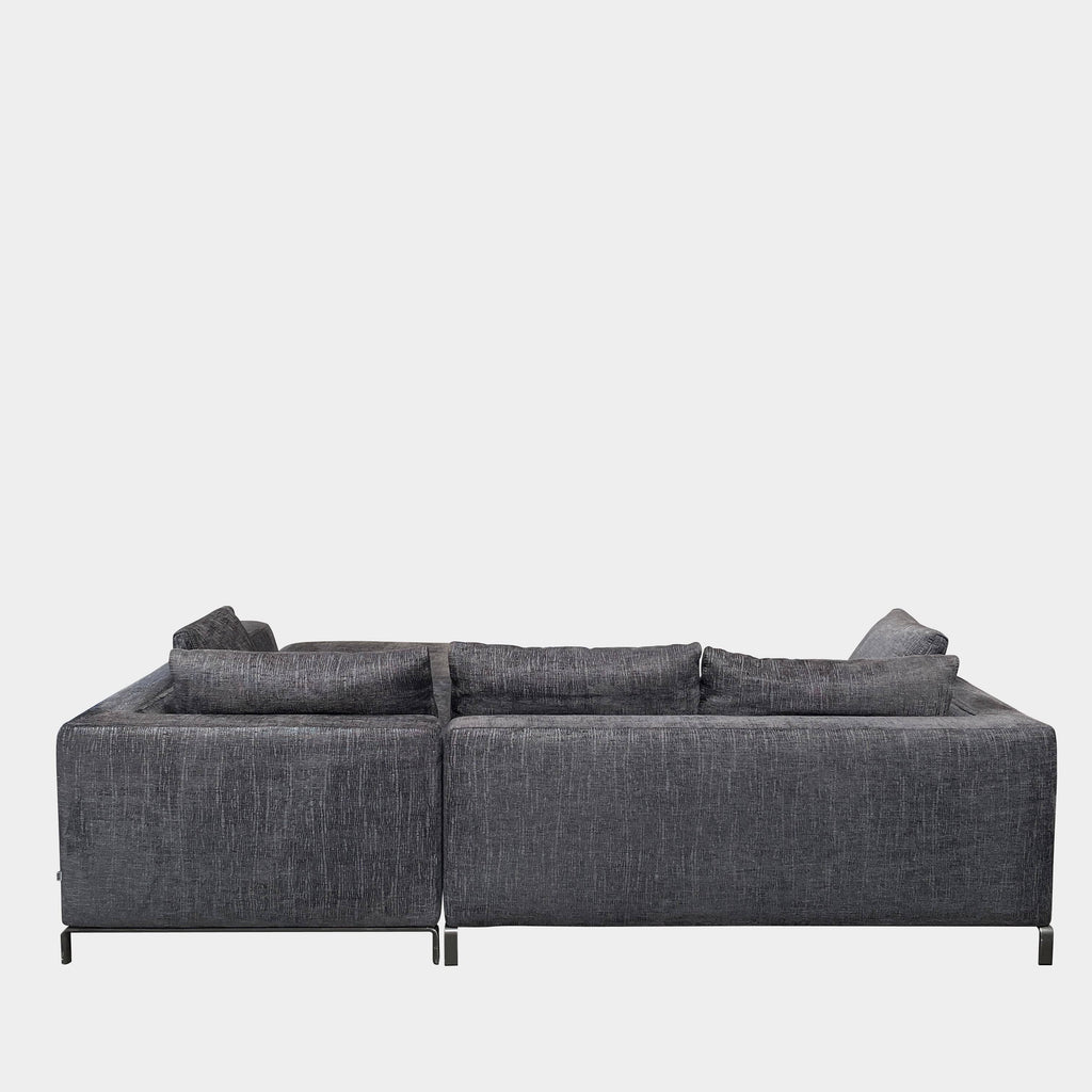 B&B Italia Ray Sectional Sofa with deep blue-gray textured fabric and additional loose cushions, isolated on a white background.