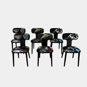 A set of six black Roche Bobois Globe Trotter Operette dining chairs, featuring patterned cushions and backs, arranged in two rows against a plain white background.