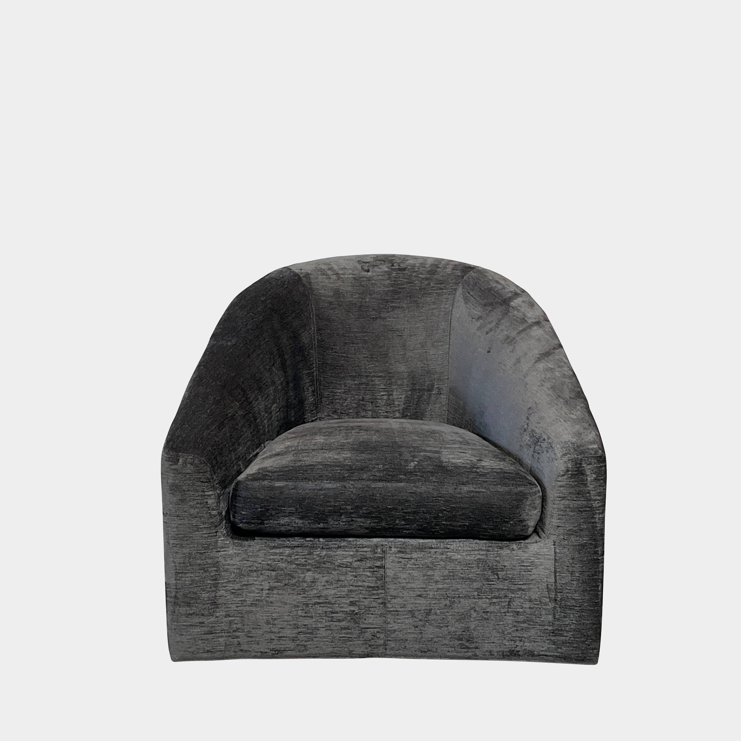 The Minotti Quinn Swivel Lounge Chair Set of 2 showcases a minimalist design with dark gray, curved forms in luxurious chenille. Ideal for the living room, these modern chairs stand out against a light gray backdrop.