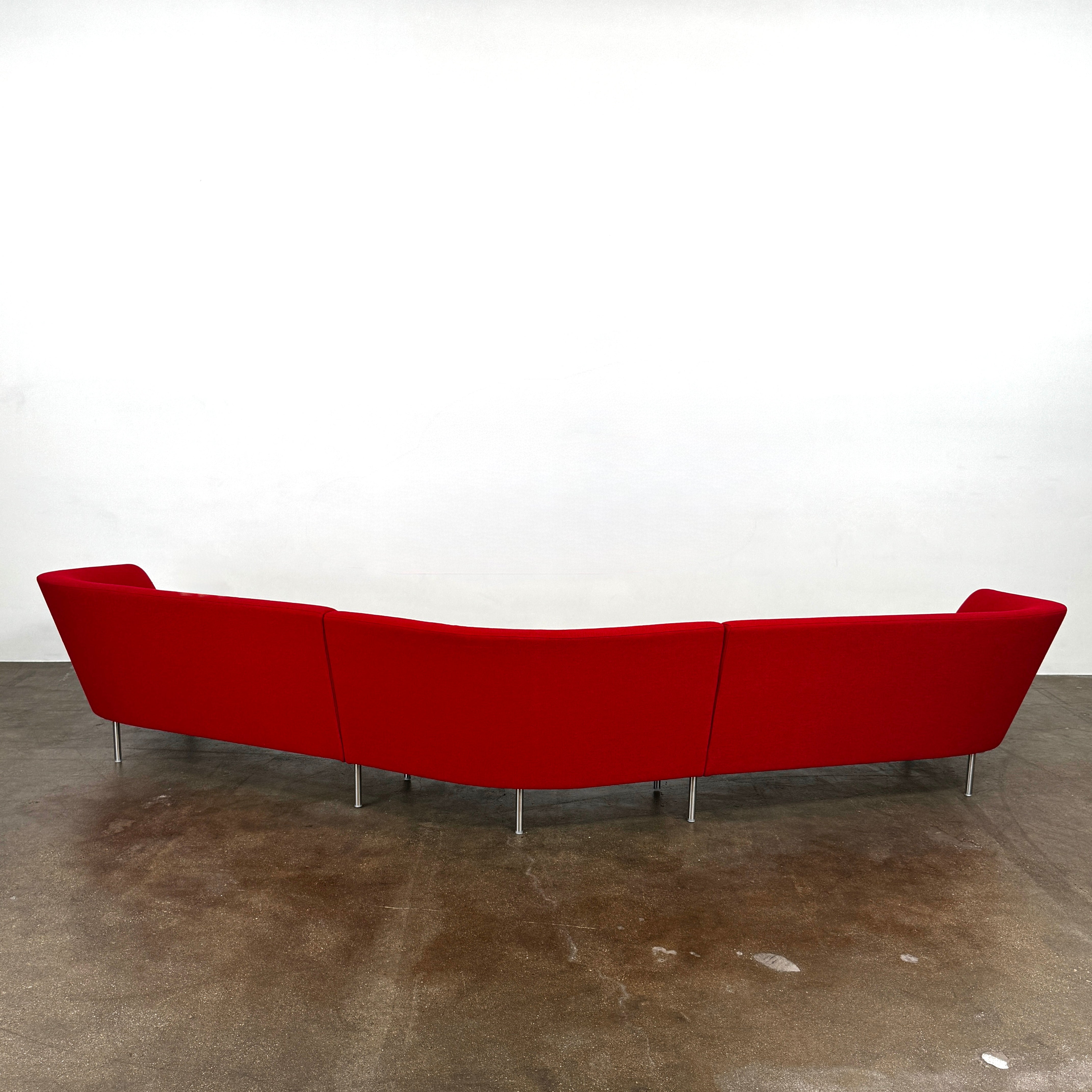 The Arper Loop Modular Sofa by Arper features a modern curved design with a geometric profile and metal legs, shown at an angle against a plain white background.