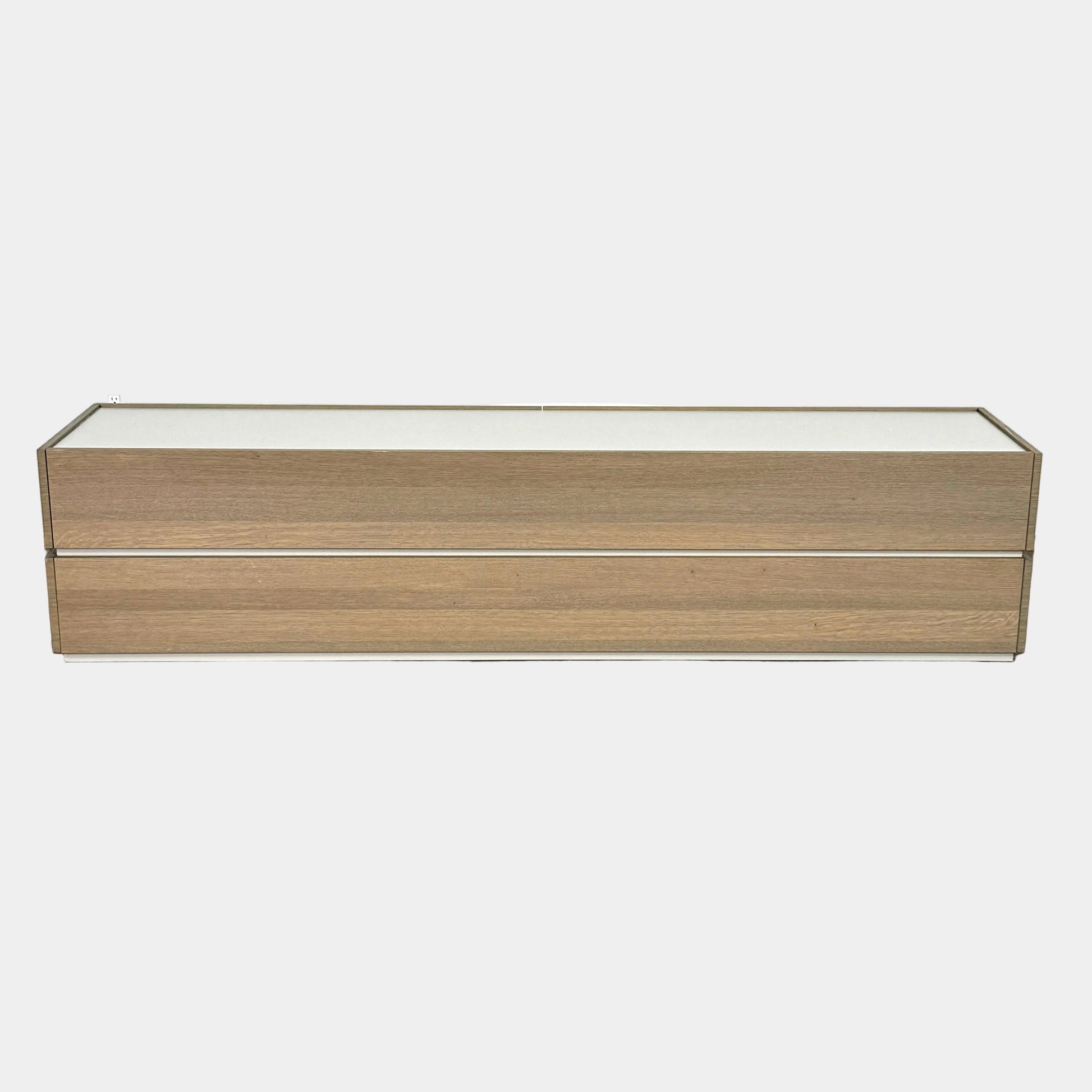 A rectangular wooden coffin with a simple, modern design and light wood finish, featuring clean lines inspired by the Sangiacomo Cidori Chest of Drawers by Sangiacomo, shown from the front against a white background.