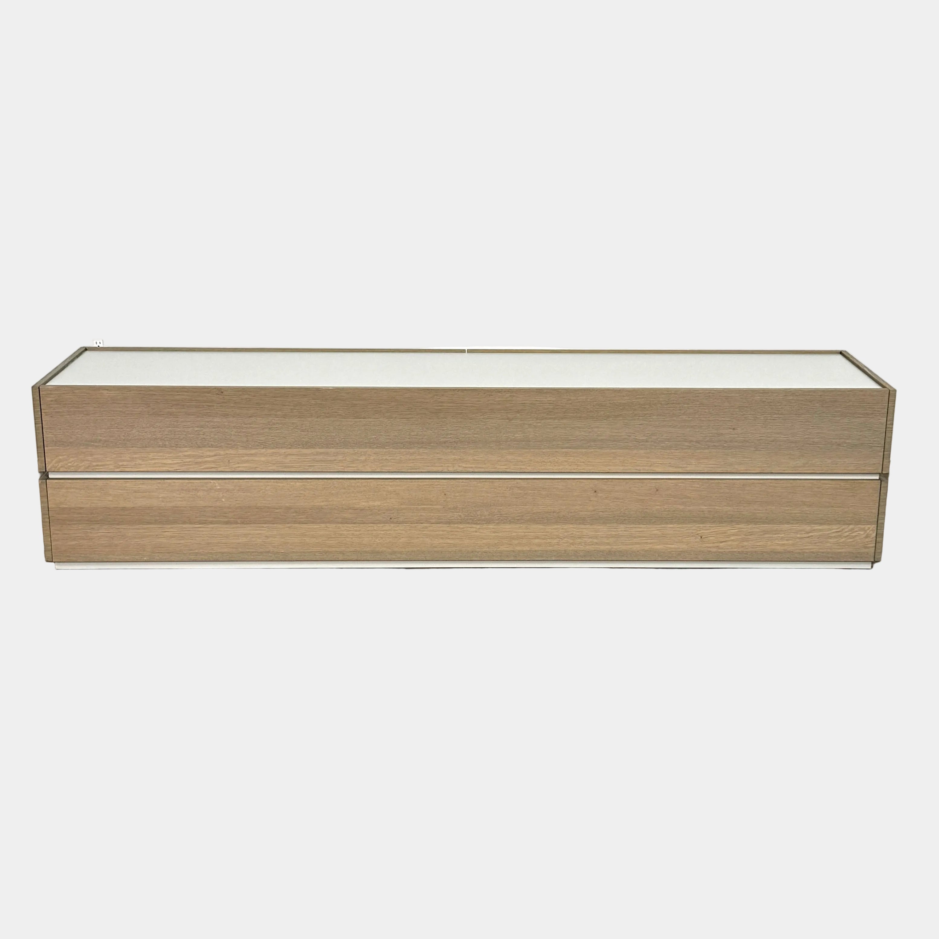 A rectangular wooden coffin with a simple, modern design and light wood finish, featuring clean lines inspired by the Sangiacomo Cidori Chest of Drawers by Sangiacomo, shown from the front against a white background.