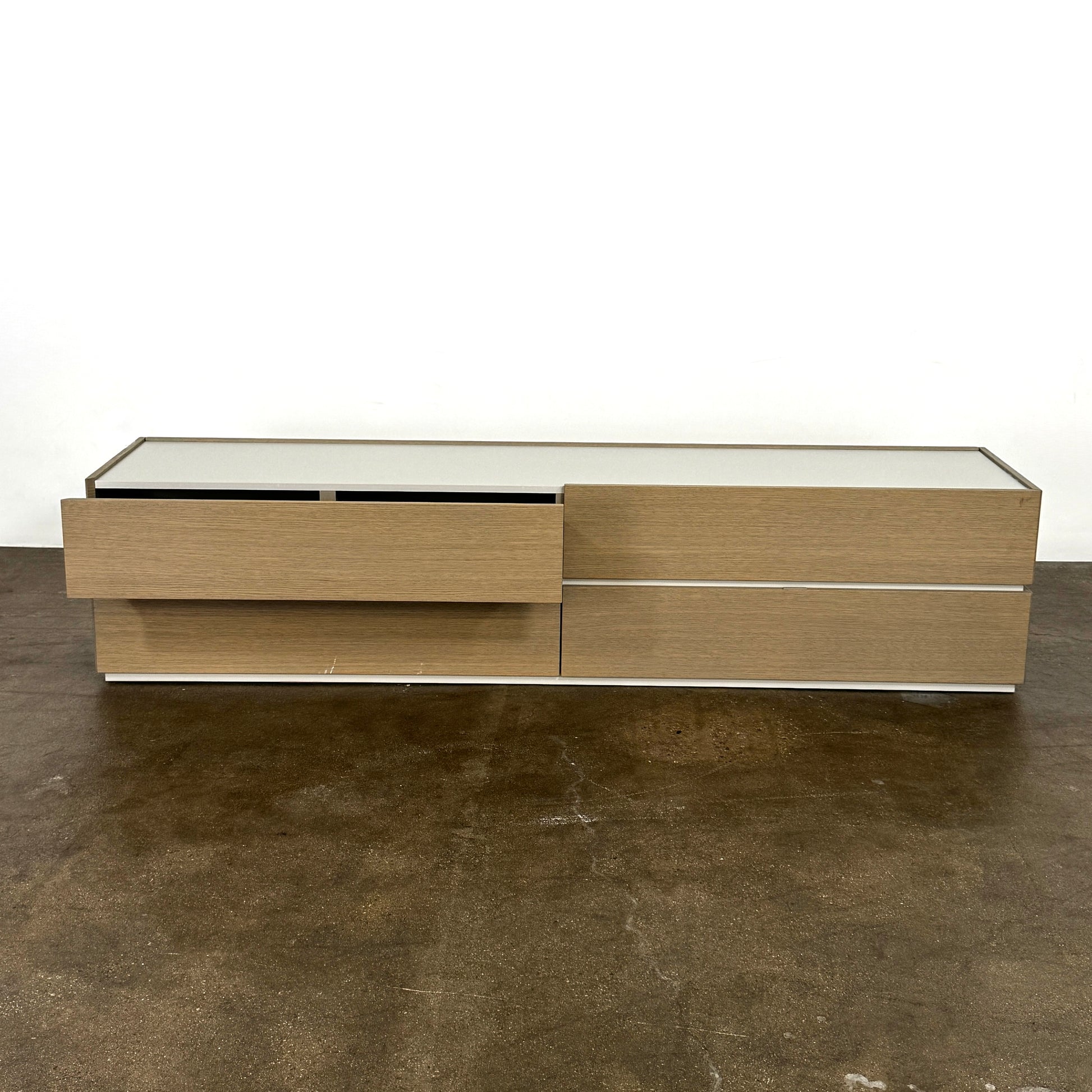 A rectangular wooden coffin with a simple, modern design and light wood finish, featuring clean lines inspired by the Sangiacomo Cidori Chest of Drawers by Sangiacomo, shown from the front against a white background.