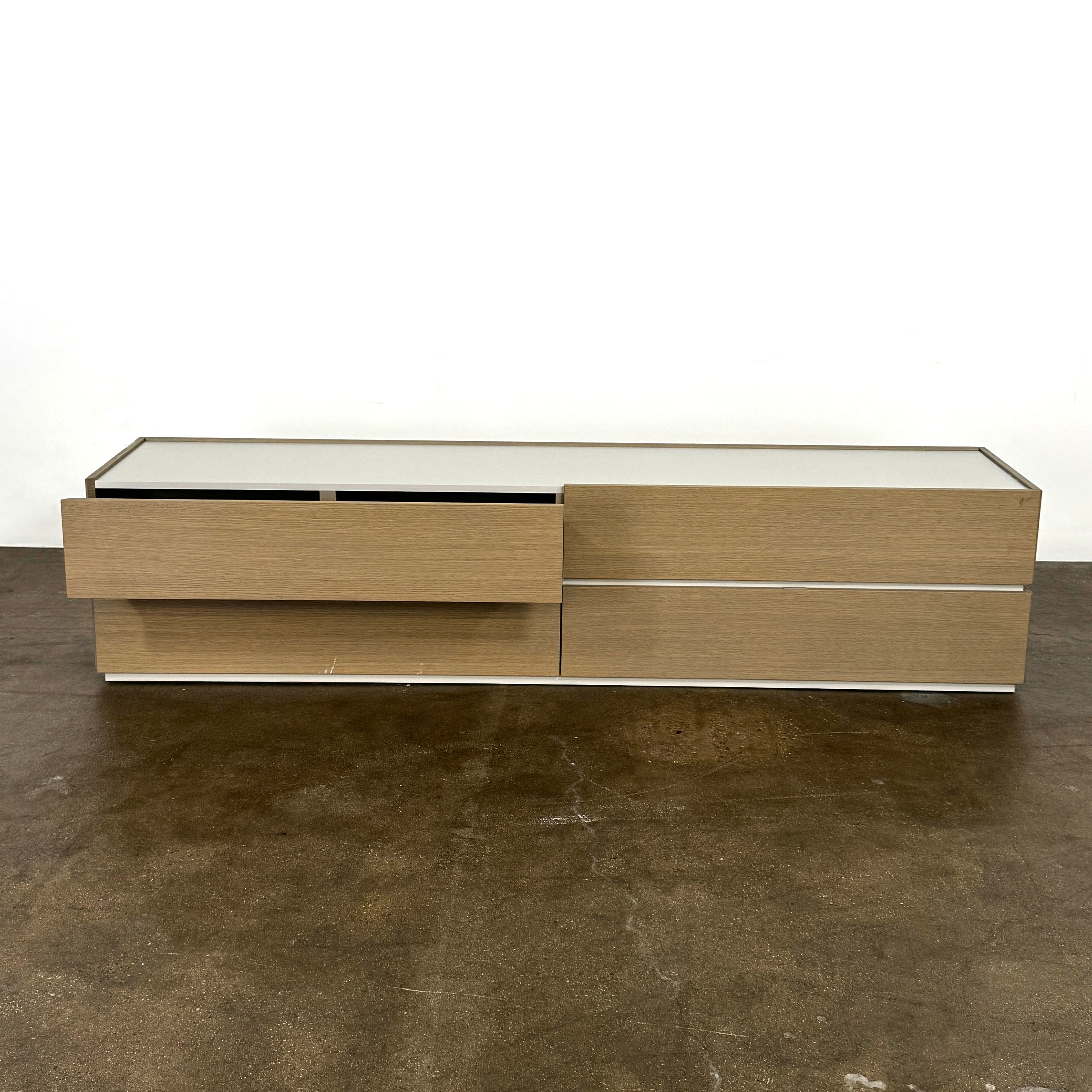 A rectangular wooden coffin with a simple, modern design and light wood finish, featuring clean lines inspired by the Sangiacomo Cidori Chest of Drawers by Sangiacomo, shown from the front against a white background.
