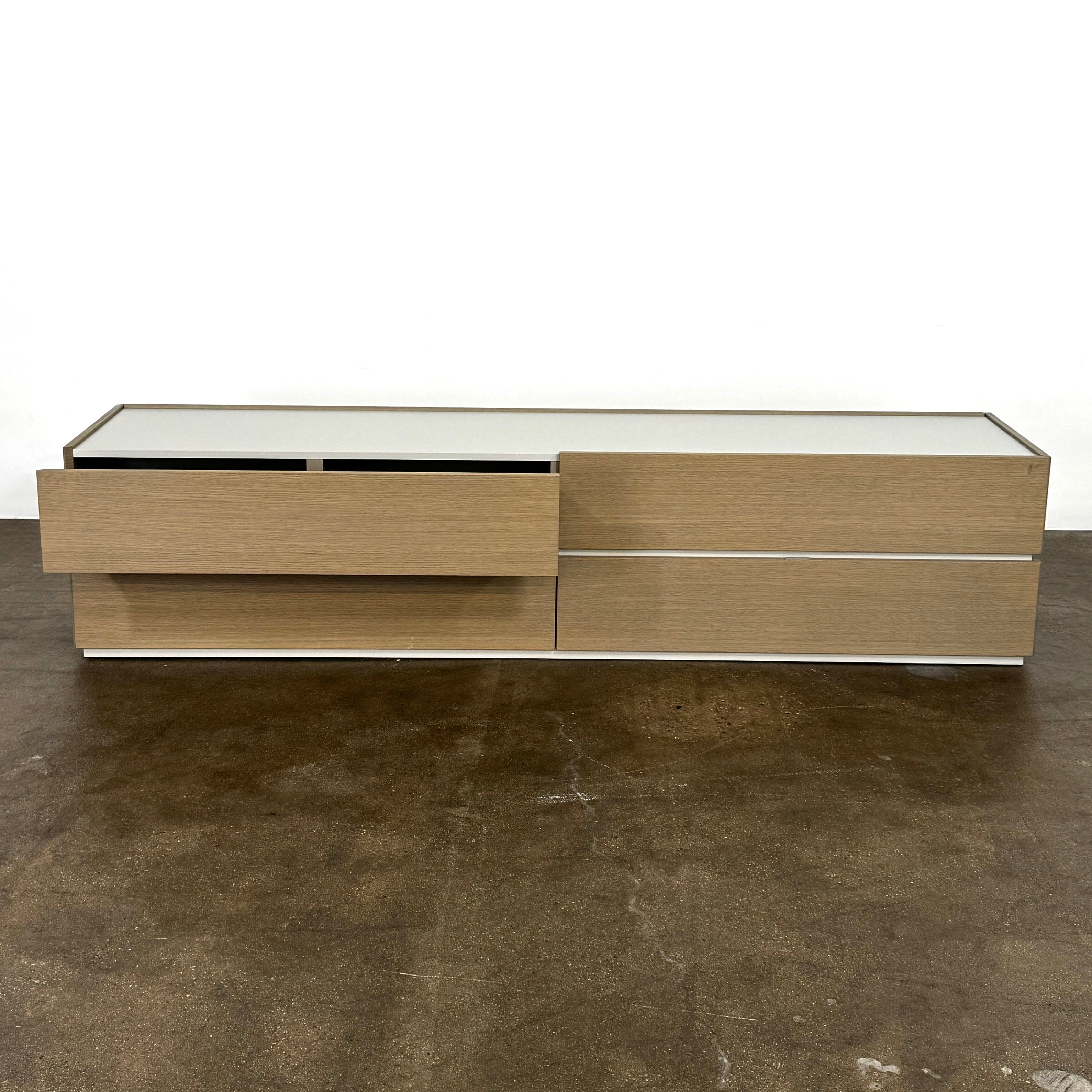 A rectangular wooden coffin with a simple, modern design and light wood finish, featuring clean lines inspired by the Sangiacomo Cidori Chest of Drawers by Sangiacomo, shown from the front against a white background.