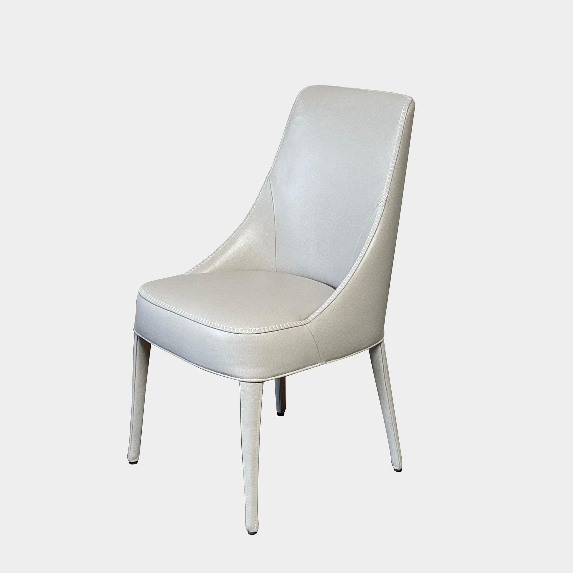 Two modern light gray Maxalto Febo high back dining chairs, embodying Italian design, against a white background.