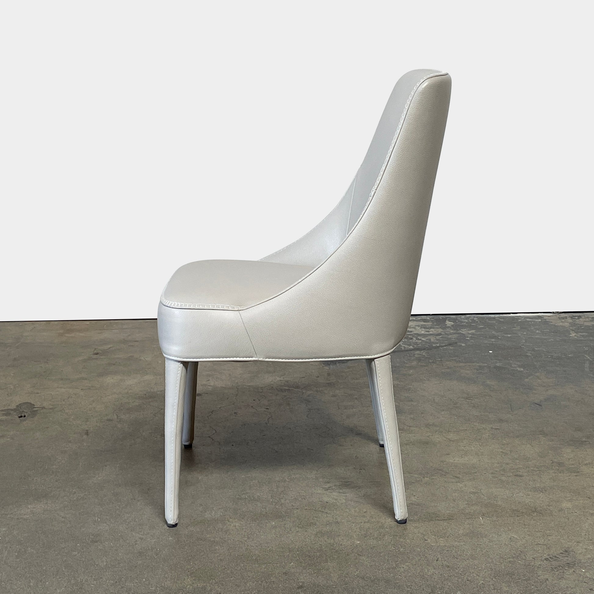 Two modern light gray Maxalto Febo high back dining chairs, embodying Italian design, against a white background.
