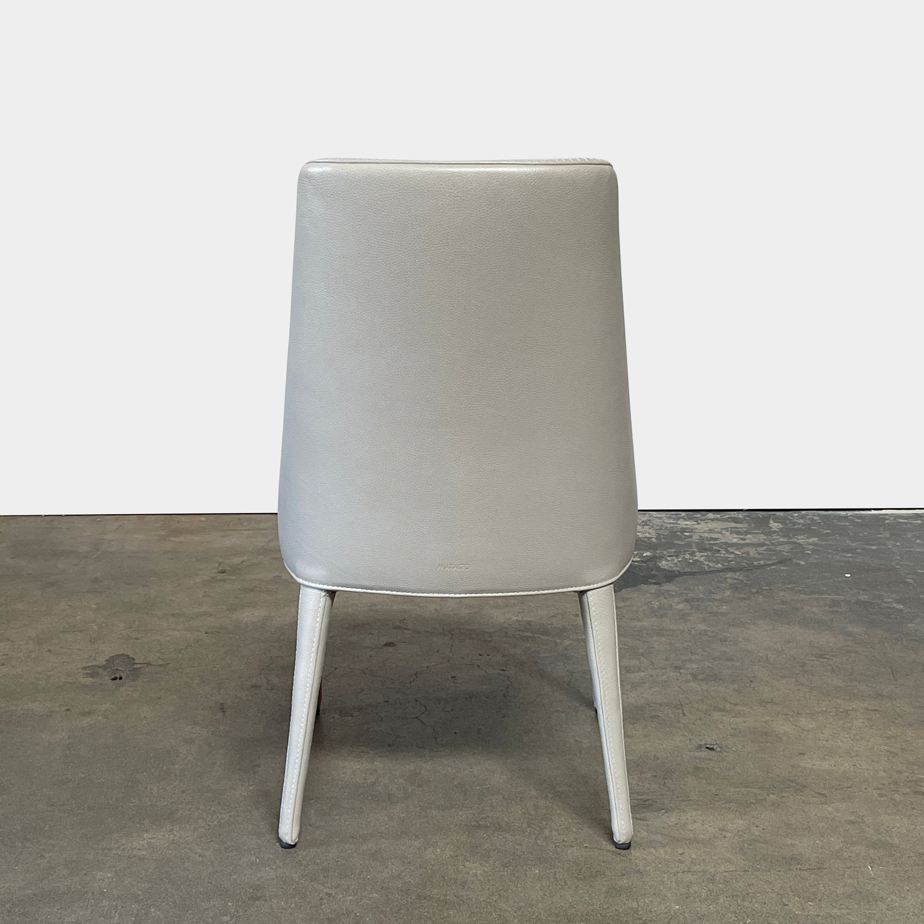 Two modern light gray Maxalto Febo high back dining chairs, embodying Italian design, against a white background.