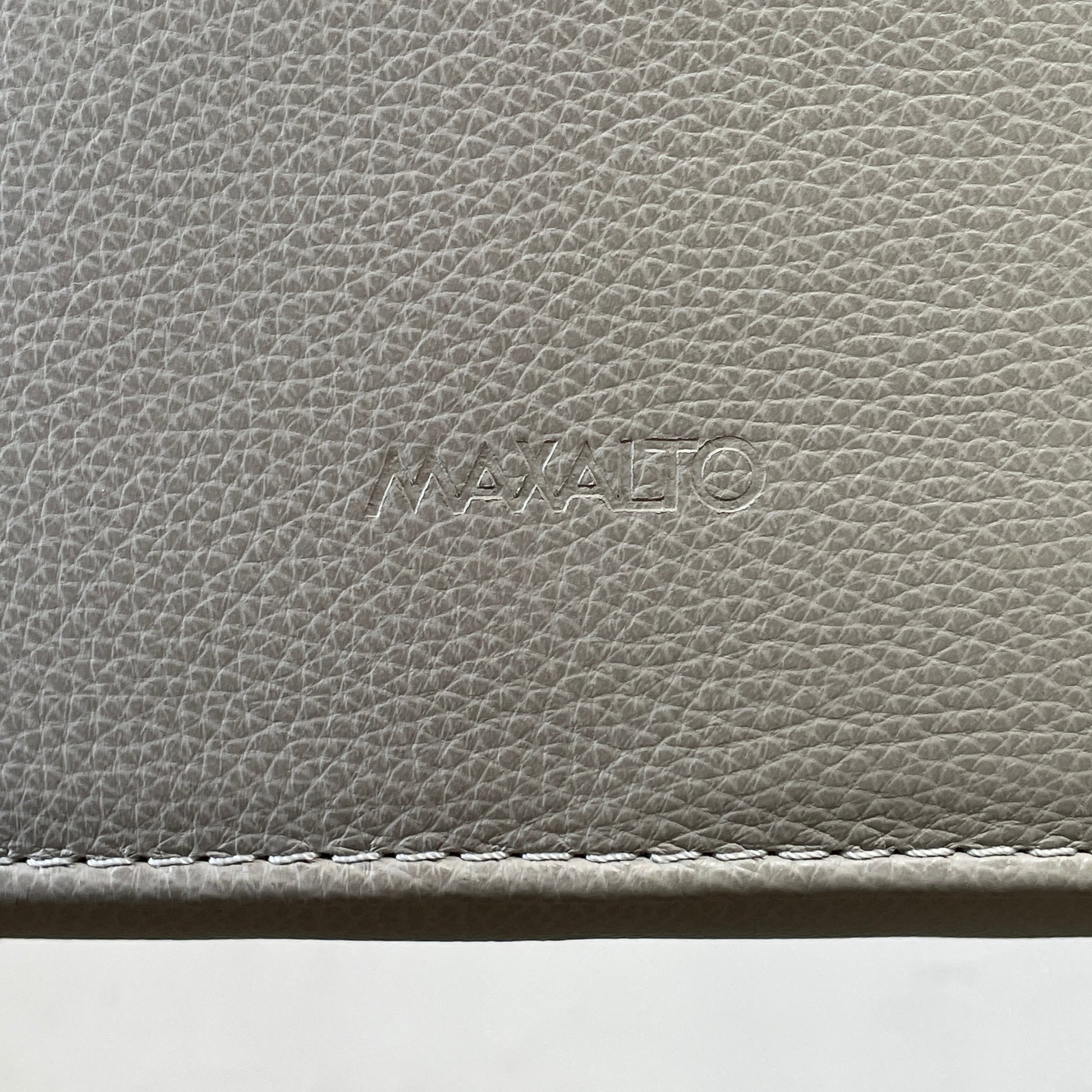 Two modern light gray Maxalto Febo high back dining chairs, embodying Italian design, against a white background.