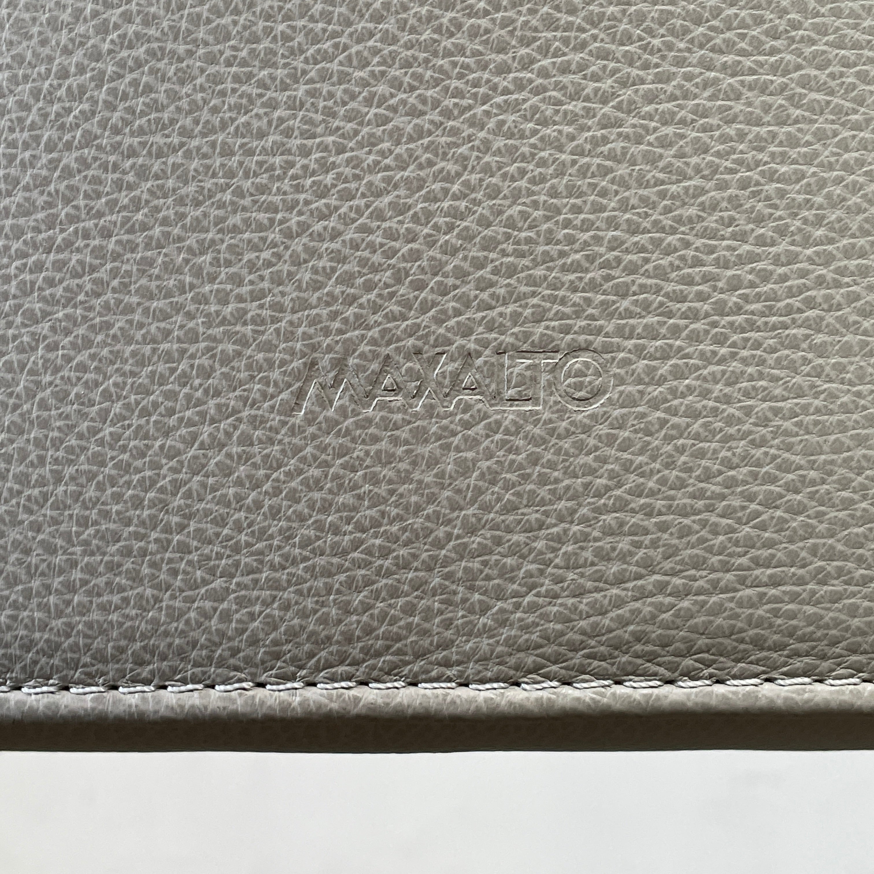 Two modern light gray Maxalto Febo high back dining chairs, embodying Italian design, against a white background.