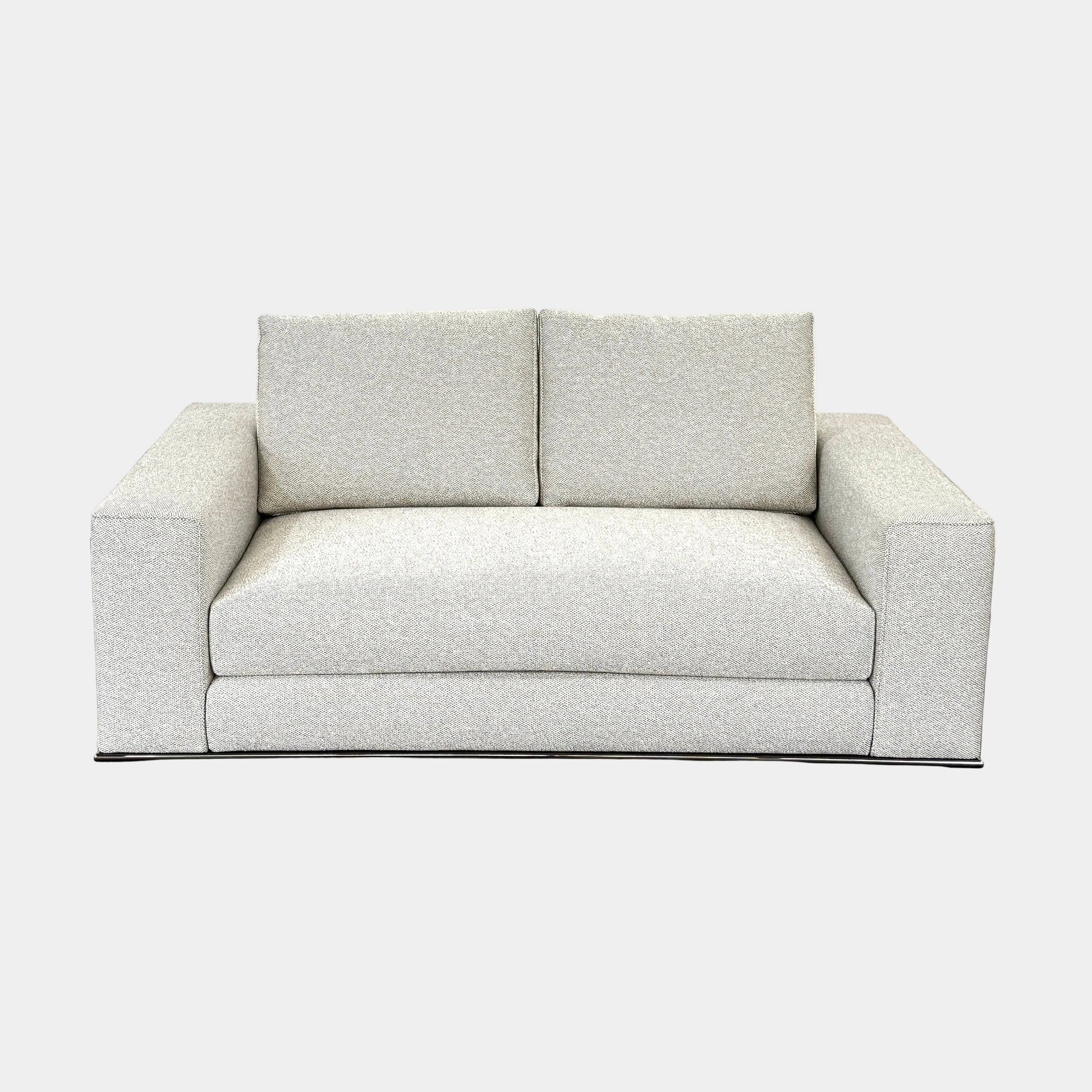 The Minotti Hamilton Love Seat 71" by Minotti, in light gray with two seat and two backrest cushions, is shown against a plain white background.