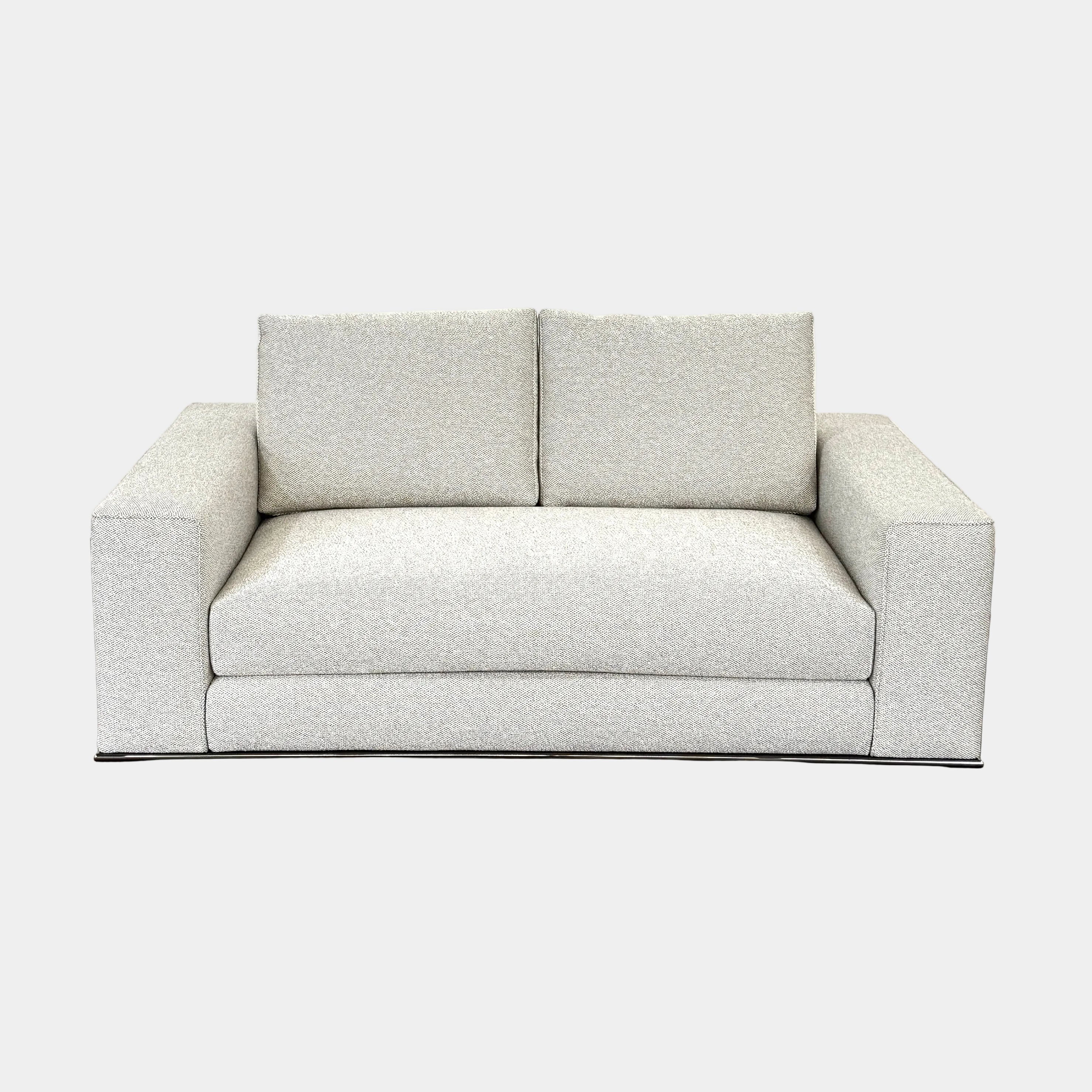 The Minotti Hamilton Love Seat 71" by Minotti, in light gray with two seat and two backrest cushions, is shown against a plain white background.