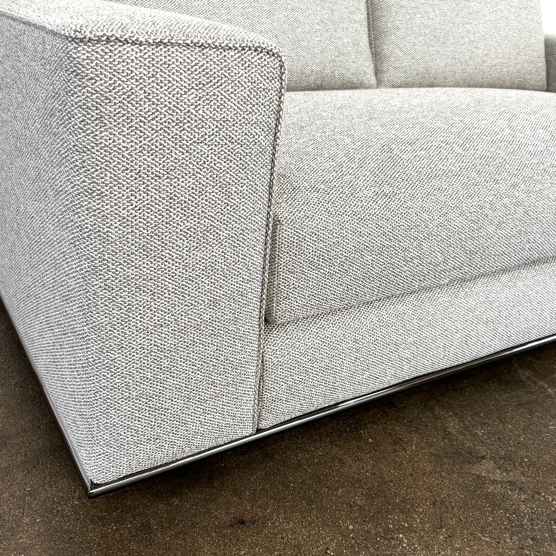 The Minotti Hamilton Love Seat 71" by Minotti, in light gray with two seat and two backrest cushions, is shown against a plain white background.