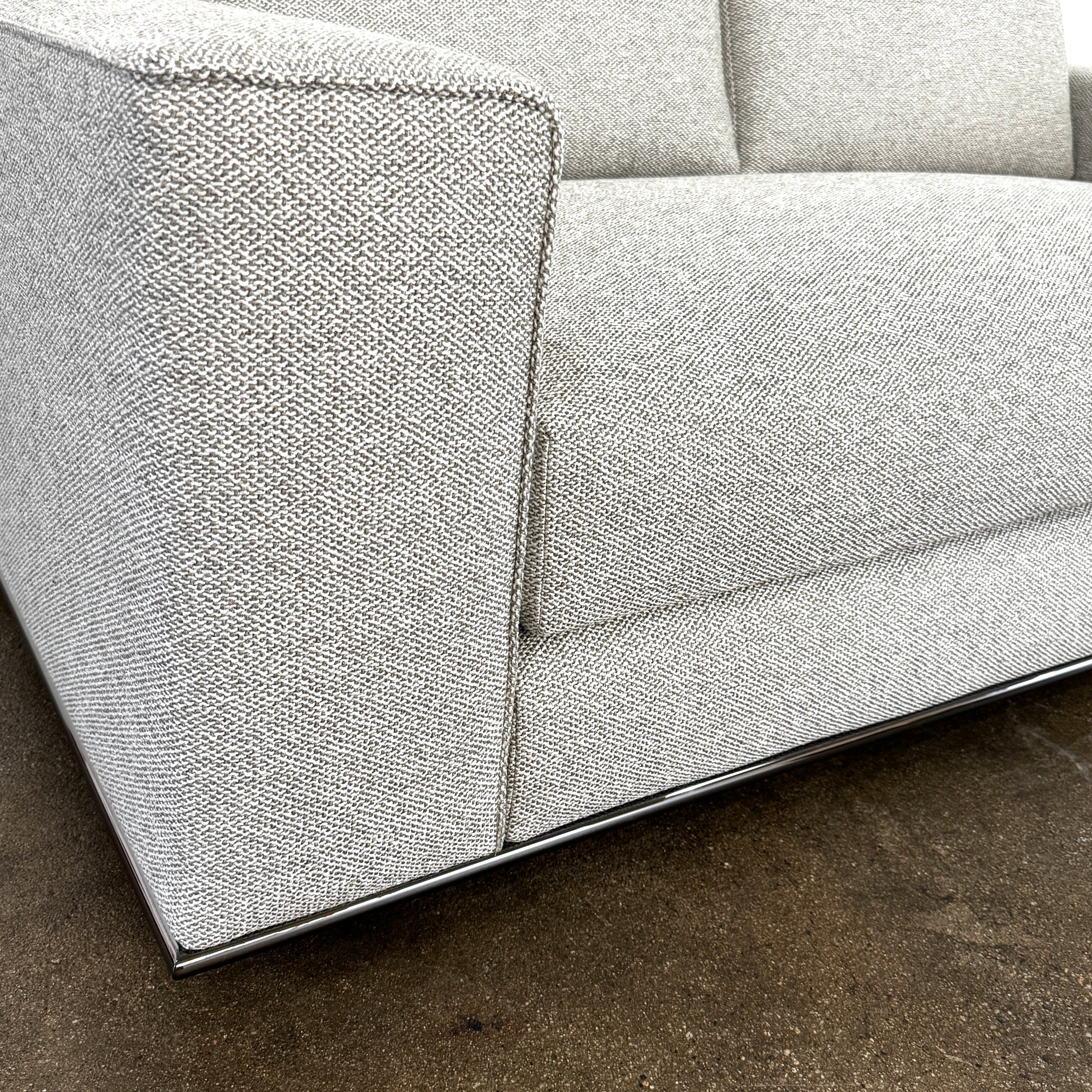The Minotti Hamilton Love Seat 71" by Minotti, in light gray with two seat and two backrest cushions, is shown against a plain white background.
