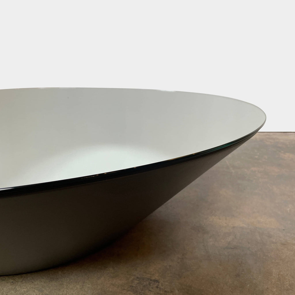 The sleek Acerbis Pond Coffee Table by Acerbis features a reflective glass top and is elegantly presented on a white background.