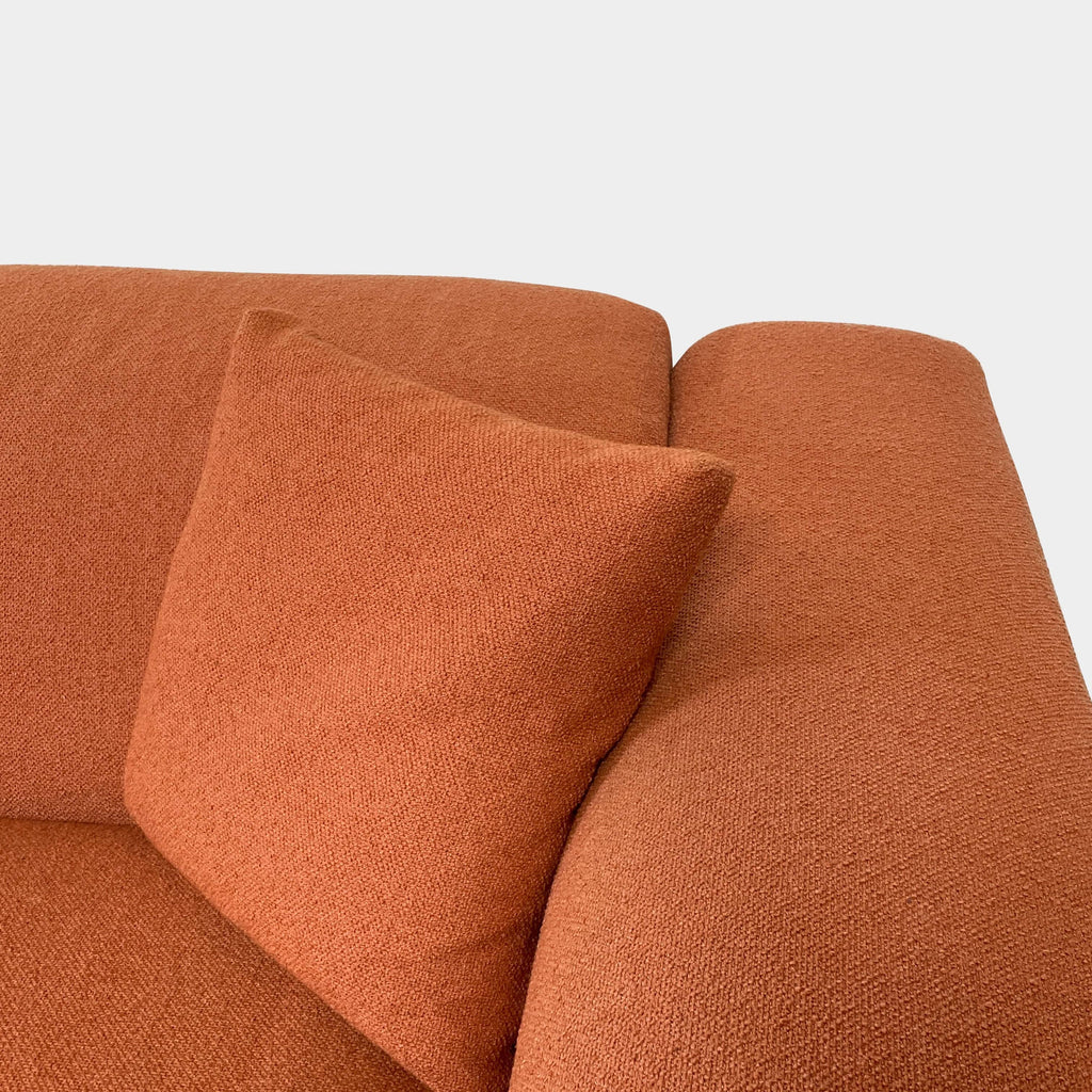 A comfortable, modern Design Within Reach Kelston Sofa in terracotta color with adjustable headrests isolated on a white background.