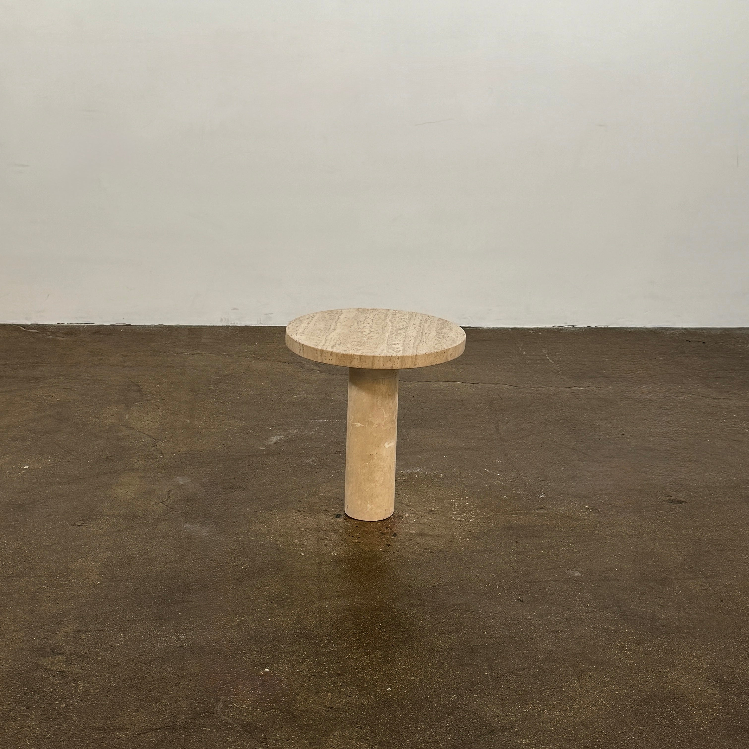 The Custom Travertine Coffee Table Set by Custom features two beige stone surfaces—one oval, one round—supported by solid travertine legs, offering sculptural elegance and modern style to any space.