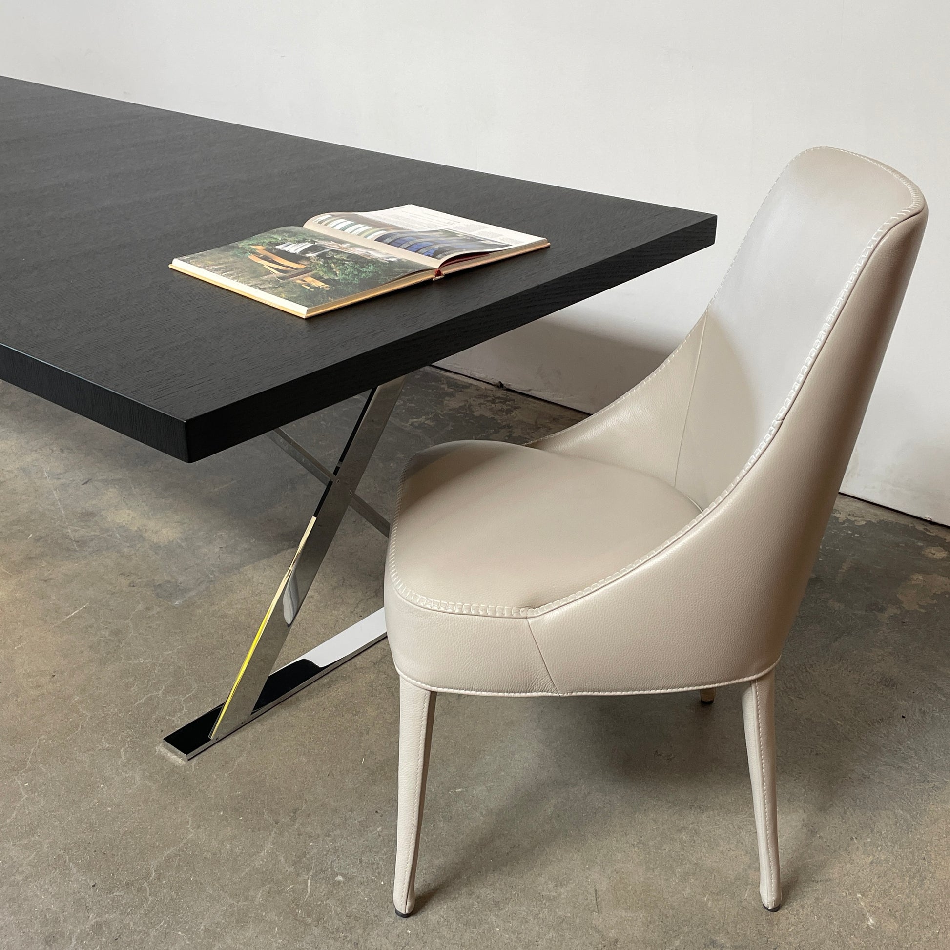 Two modern light gray Maxalto Febo high back dining chairs, embodying Italian design, against a white background.