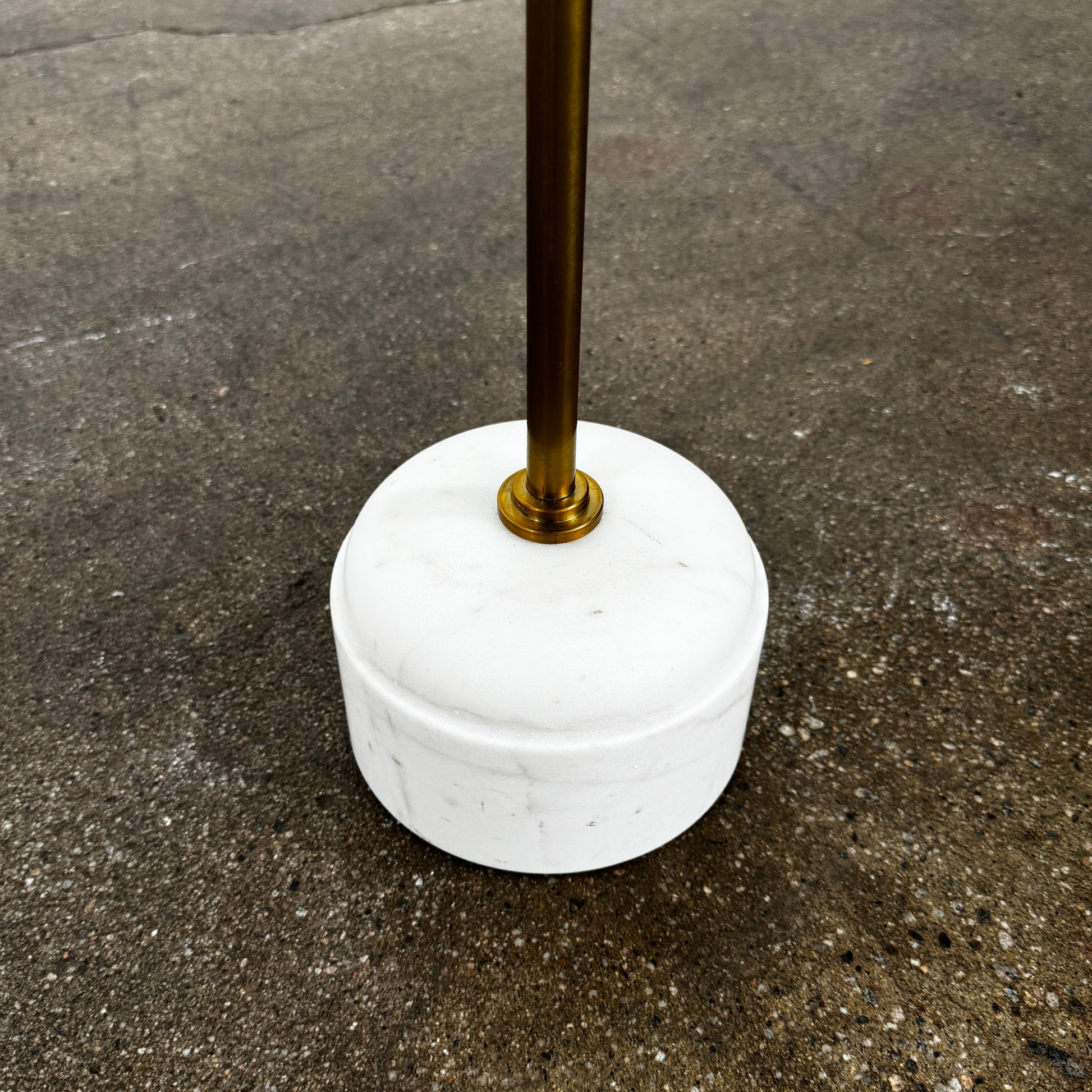 The Soho Home Fleet Side Table by Soho Home features a dark Verde Bosque marble top, slender antique brass stem, and a white cylindrical marble base, shown against a plain light background.