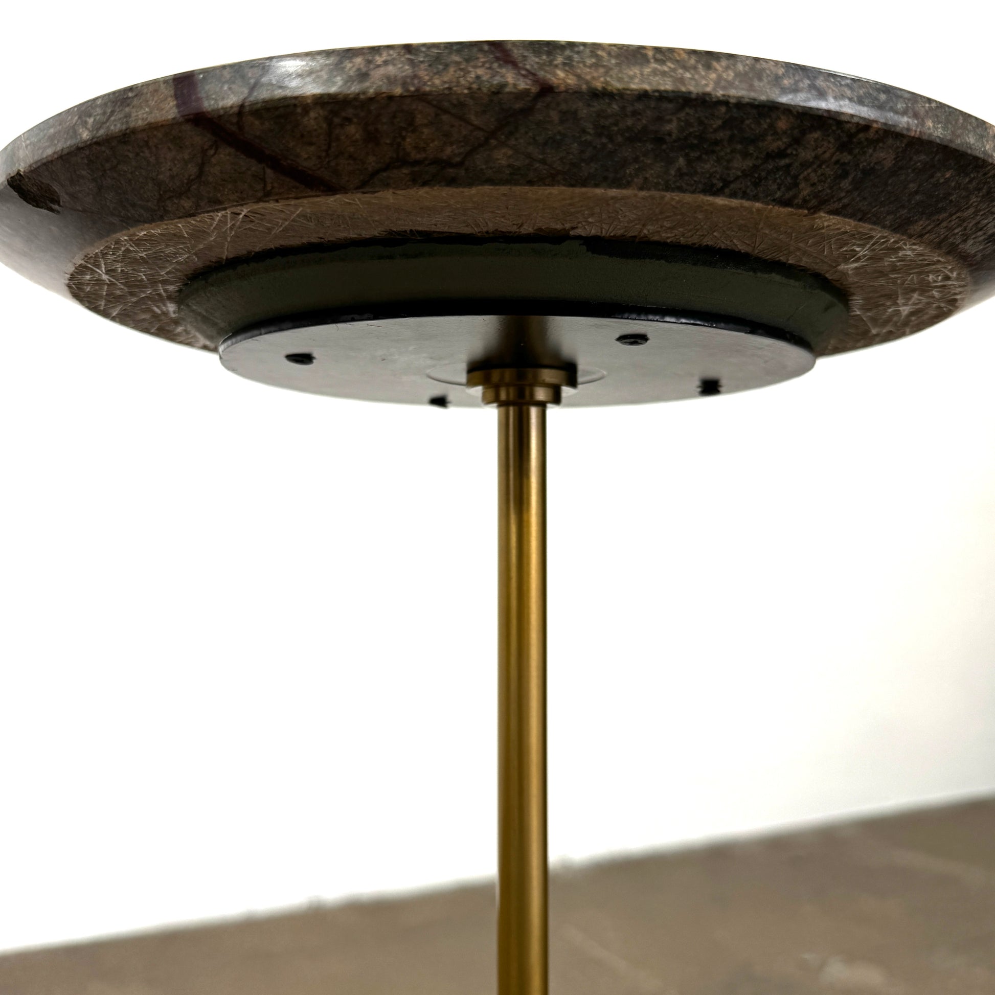 The Soho Home Fleet Side Table by Soho Home features a dark Verde Bosque marble top, slender antique brass stem, and a white cylindrical marble base, shown against a plain light background.