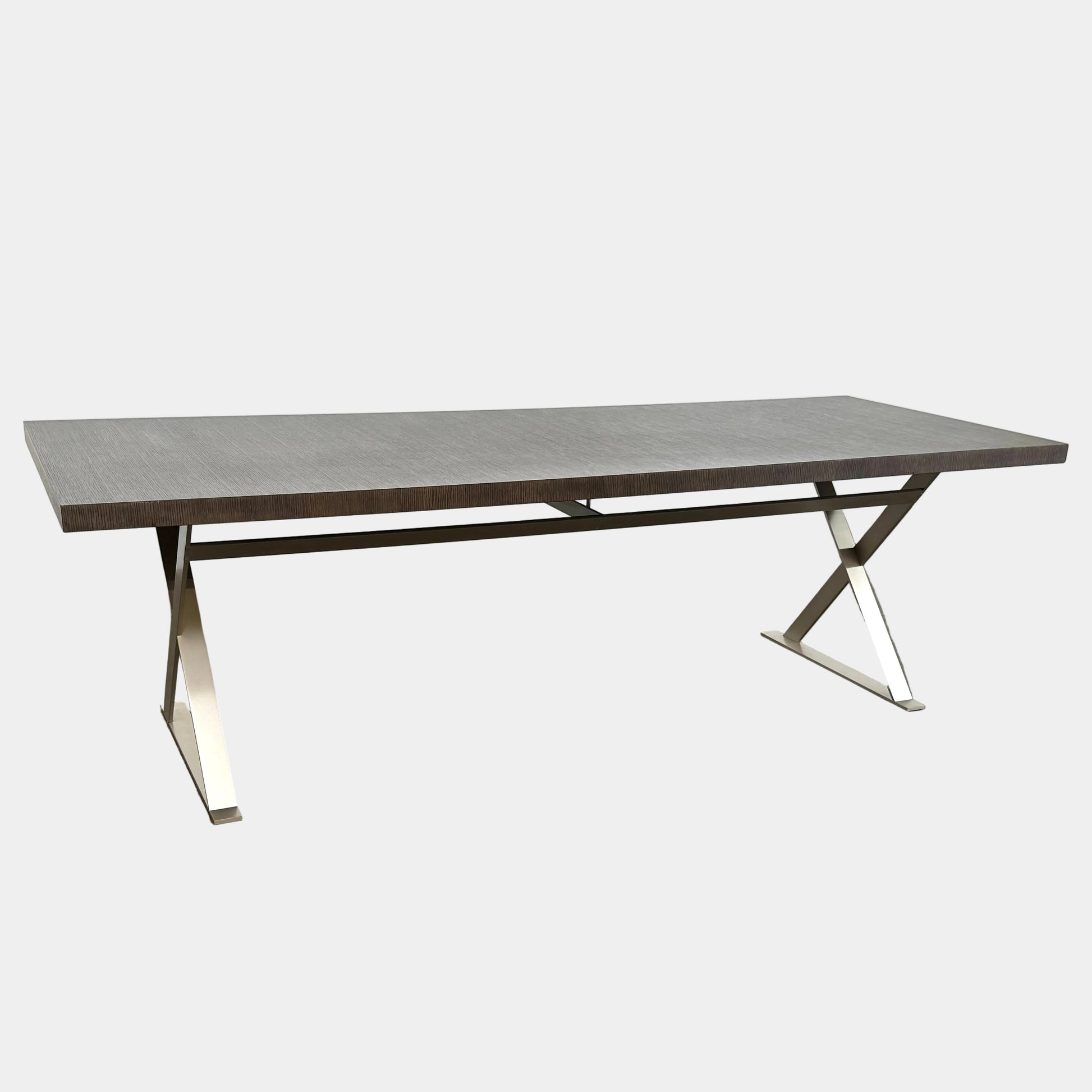 The Maxalto Max Table Grey Oak by Maxalto features a grey oak wooden top, metal legs, and an angular modern design—ideal for enhancing any dining space. Displayed on a plain white background.