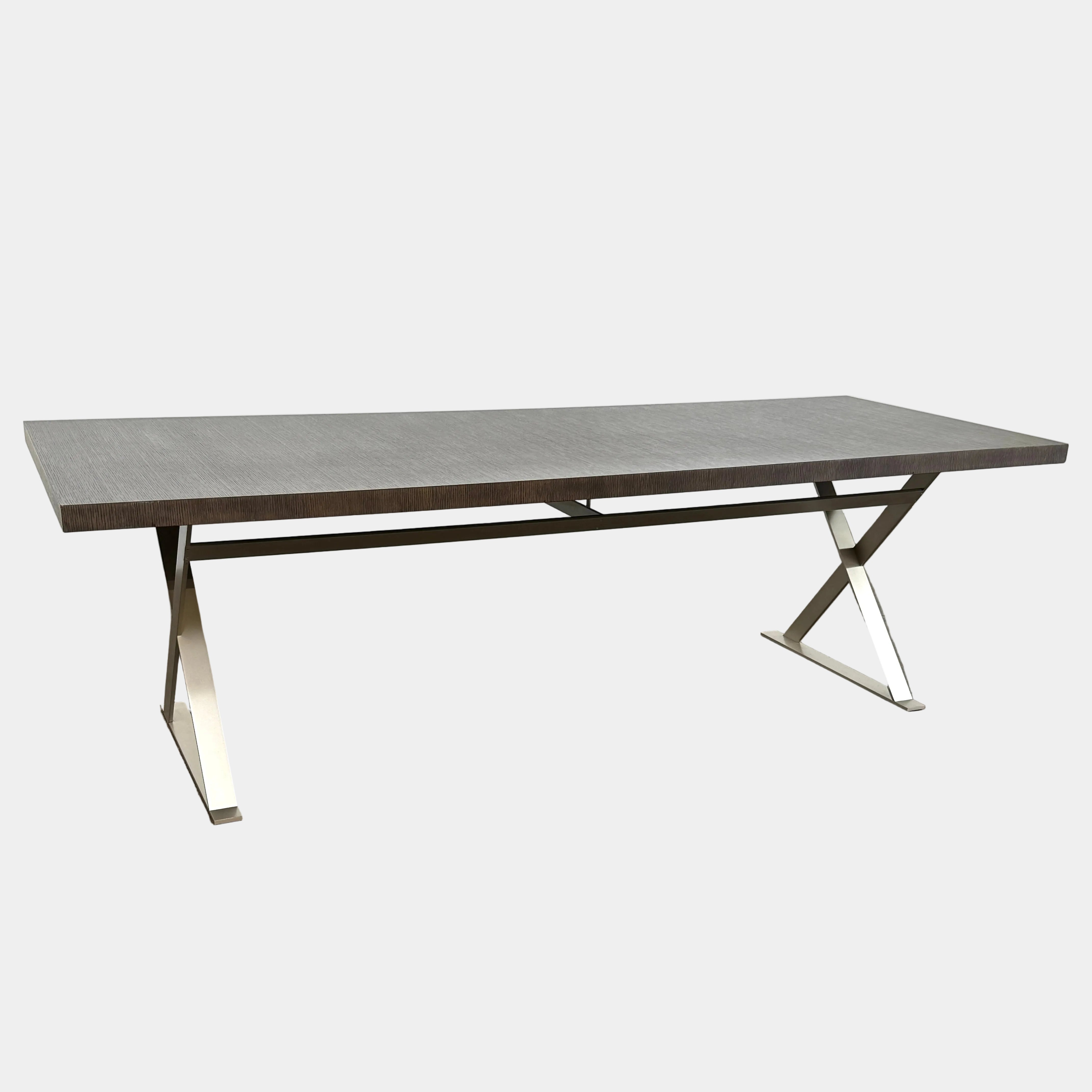 The Maxalto Max table in Grey Oak features a rectangular flat top and a striking metal X-base, shown against a plain white background.