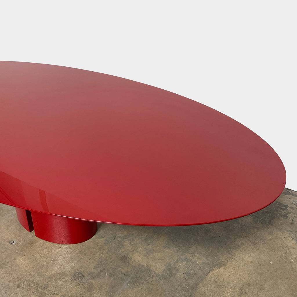 A red oval MDF Italia NVL dining table on a white background.
