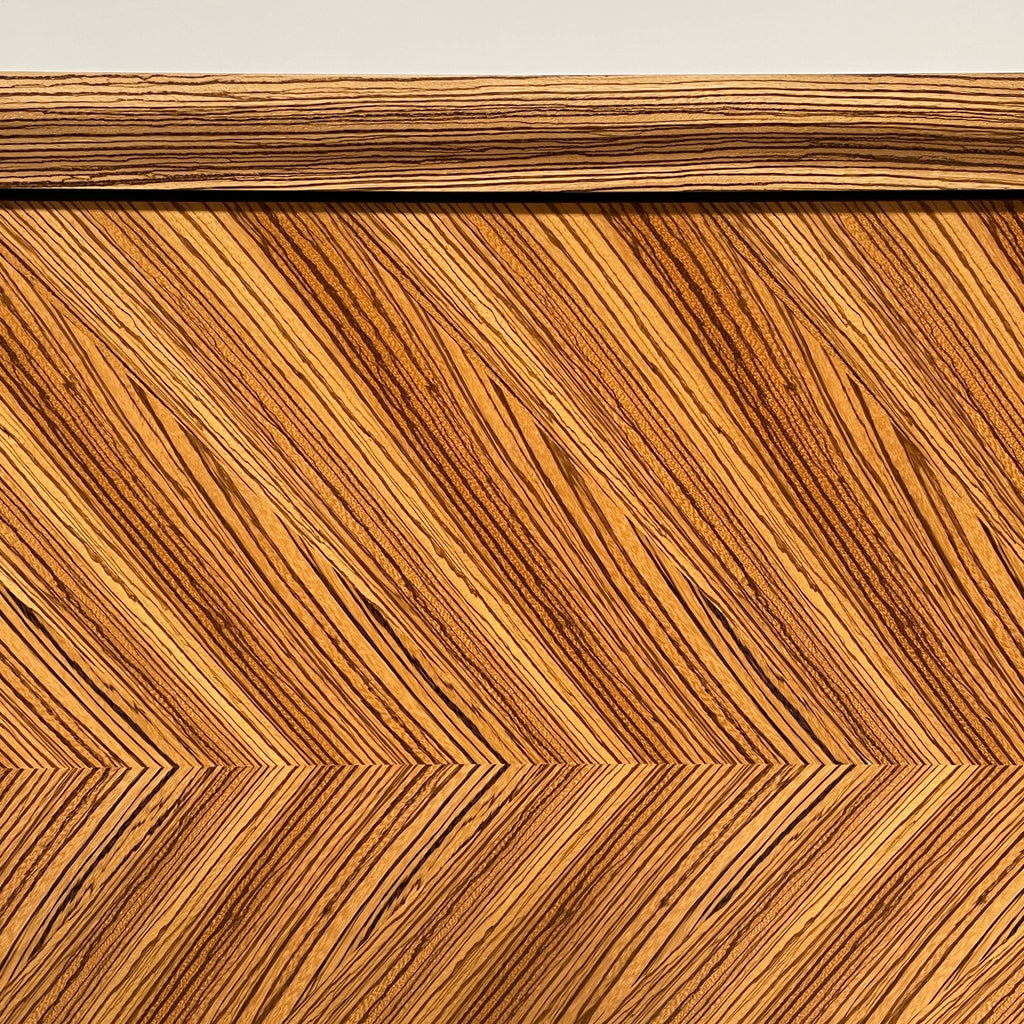 A Promemoria Oolong Wooden Cabinet with a chevron pattern.