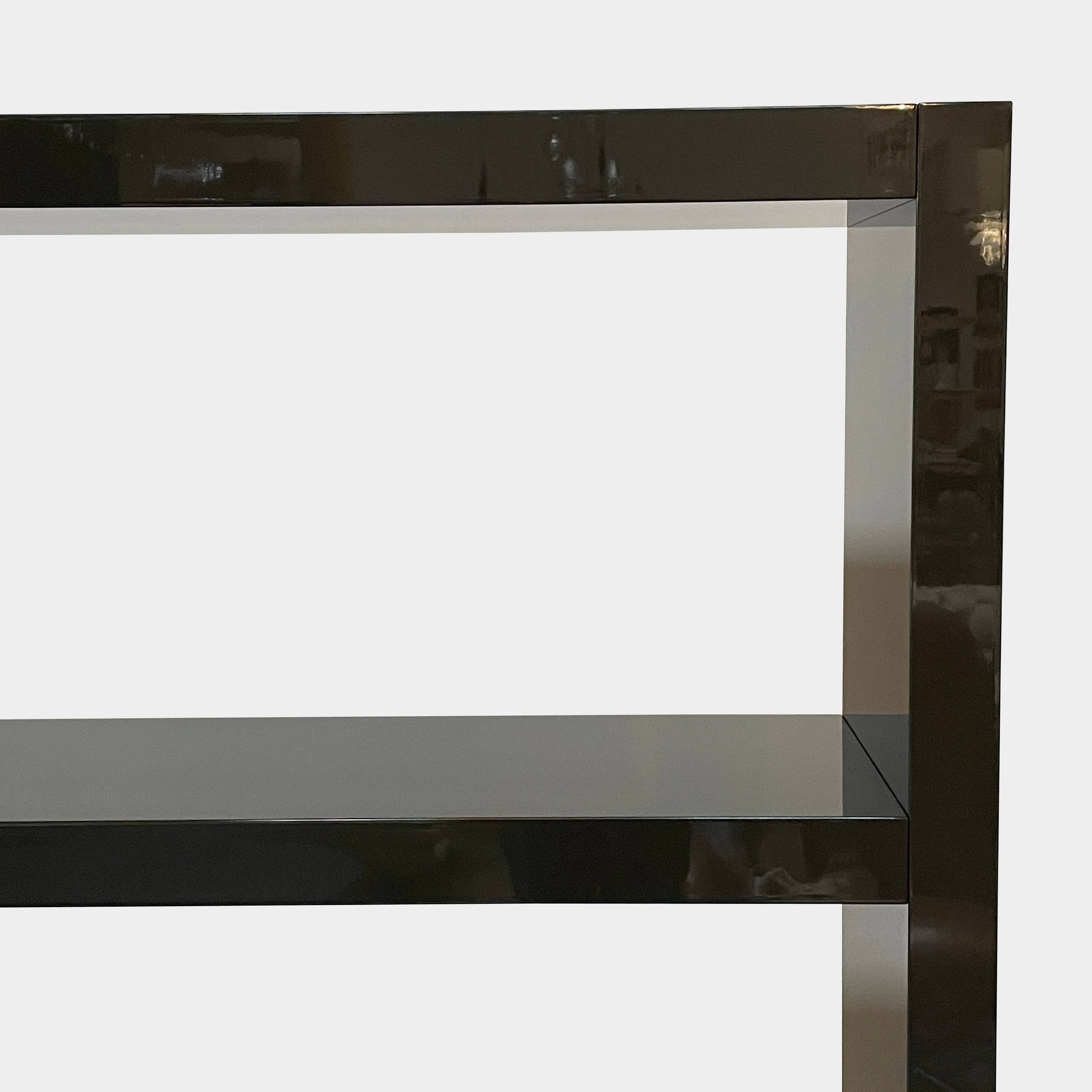 A black Minotti Johns Bookcase with three shelves on it.