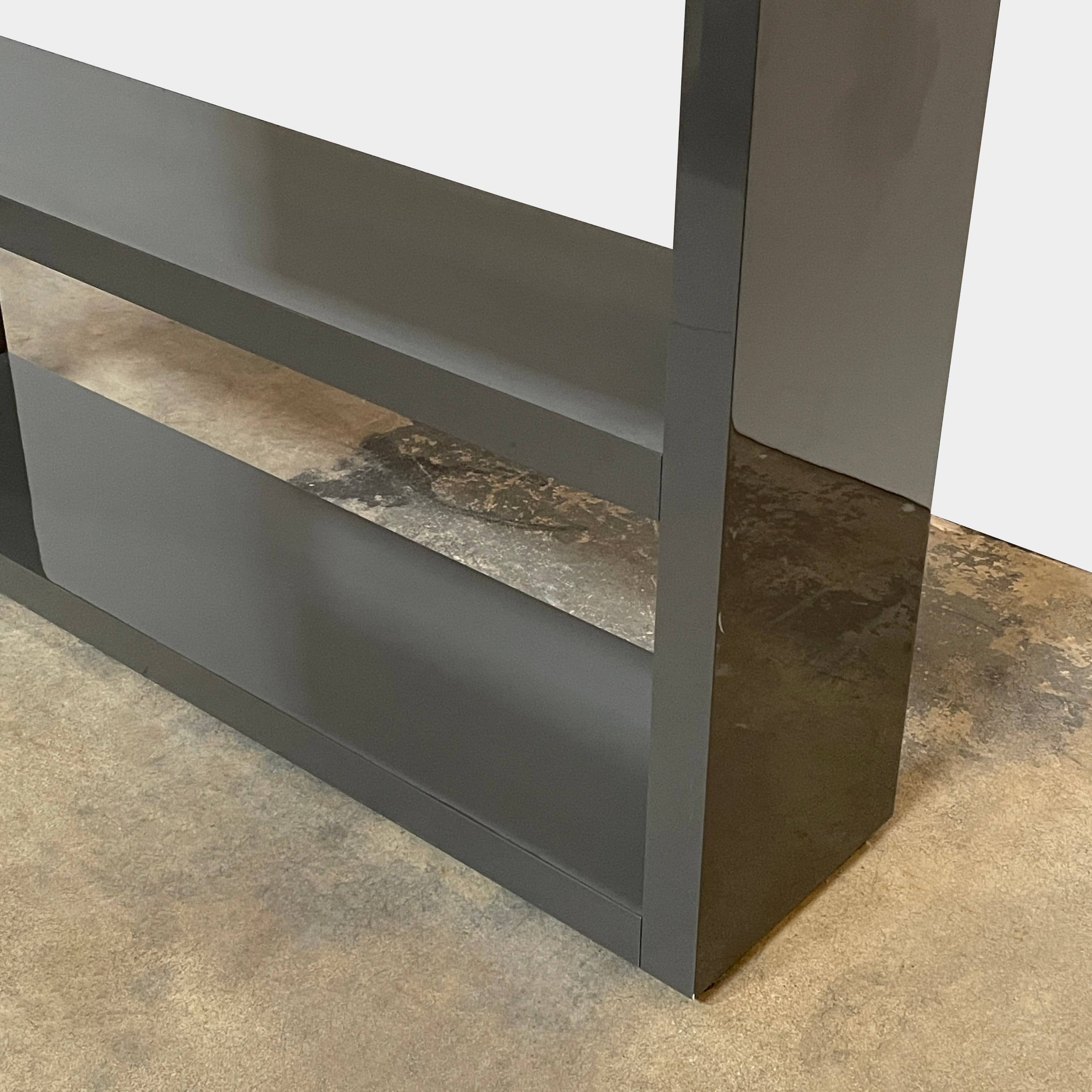 A black Minotti Johns Bookcase with three shelves on it.