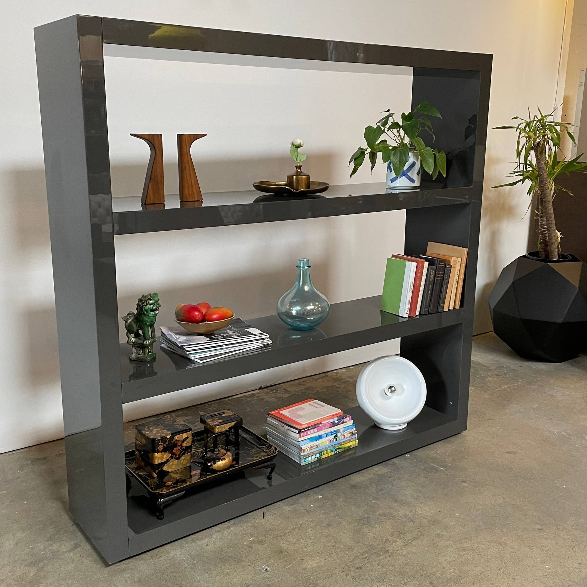 A black Minotti Johns Bookcase with three shelves on it.