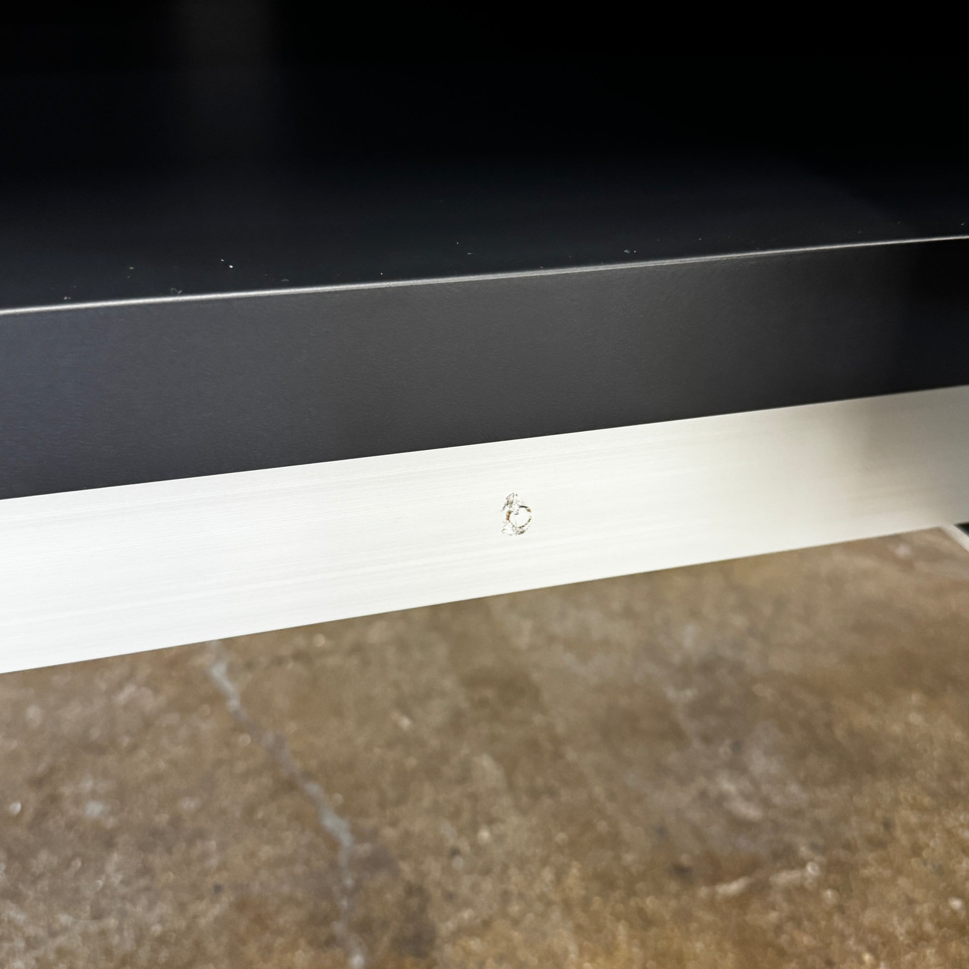 The B&B Italia Athos Console features a modern black rectangular design with a glossy finish and metal legs, showcased against a plain white background.