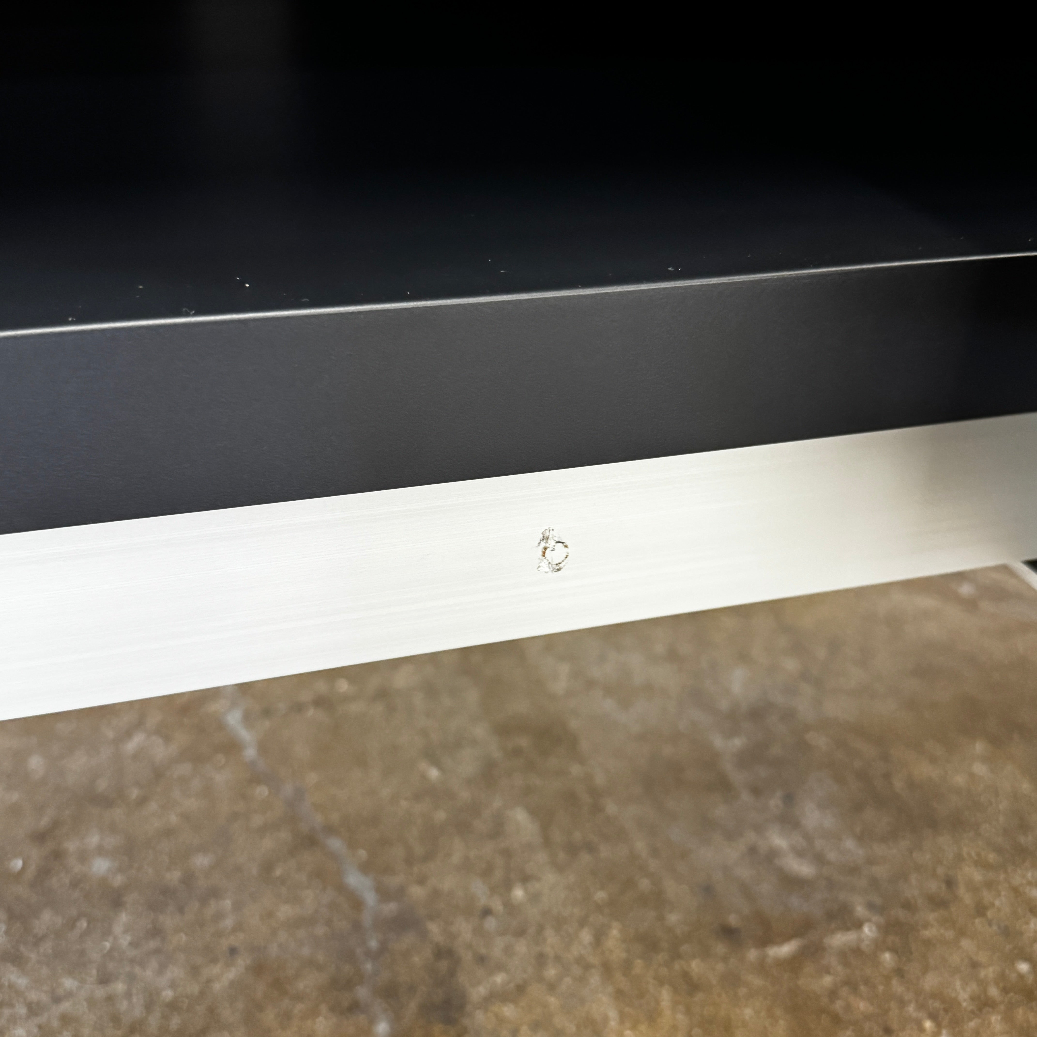 The B&B Italia Athos Console features a modern black rectangular design with a glossy finish and metal legs, showcased against a plain white background.