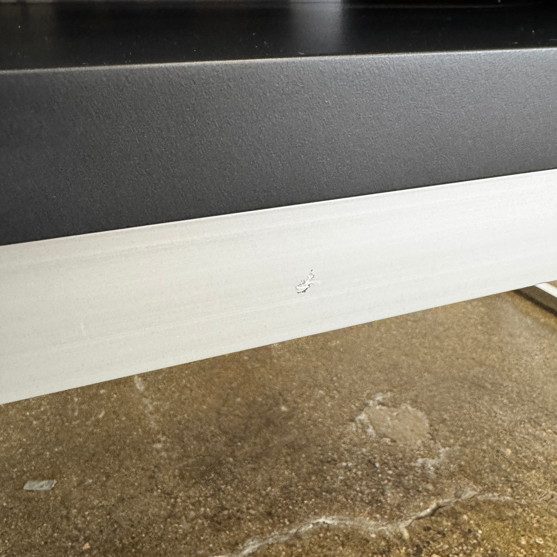 The B&B Italia Athos Console features a modern black rectangular design with a glossy finish and metal legs, showcased against a plain white background.