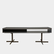 A Minotti Close Console with black legs and a glass top.