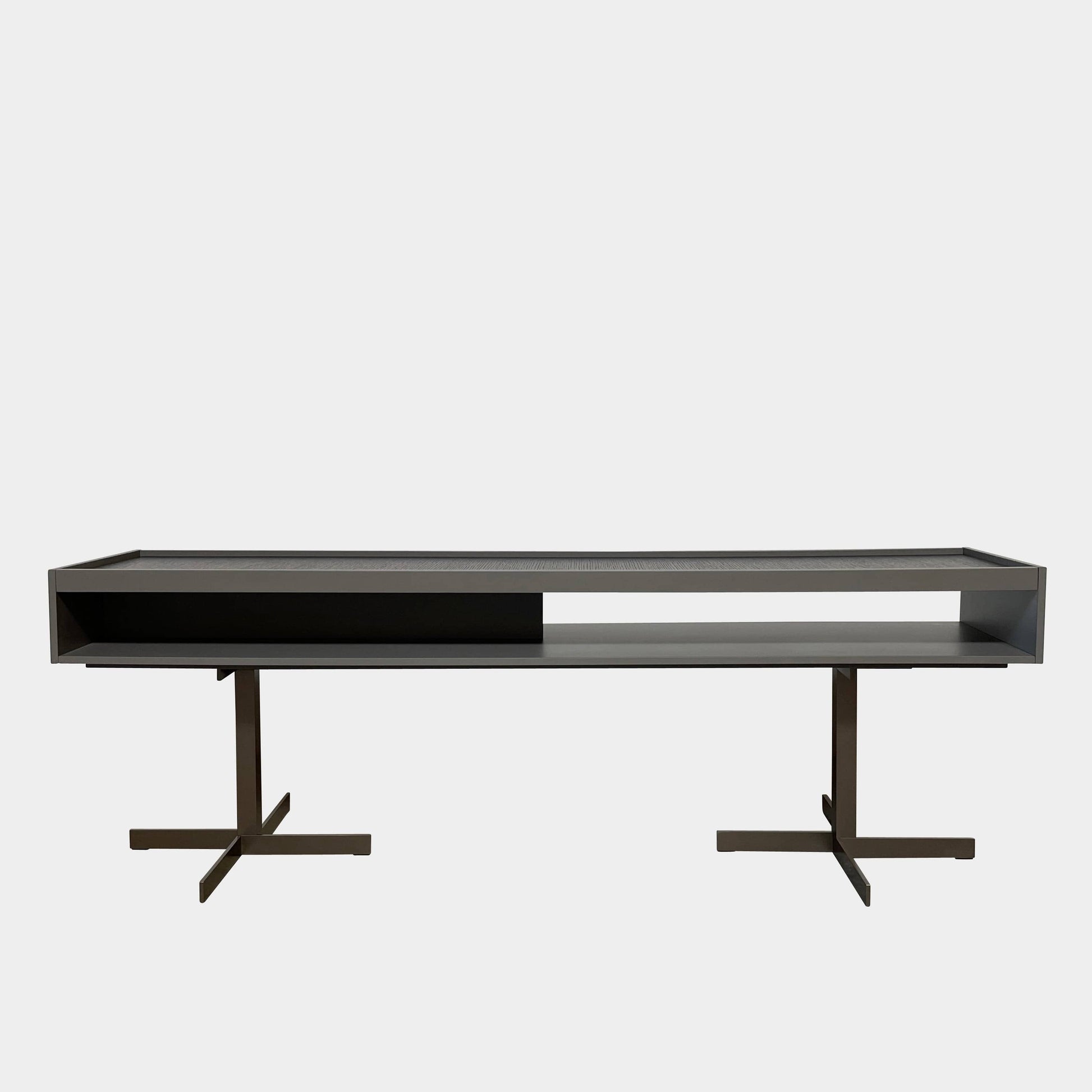 A Minotti Close Console with black legs and a glass top.