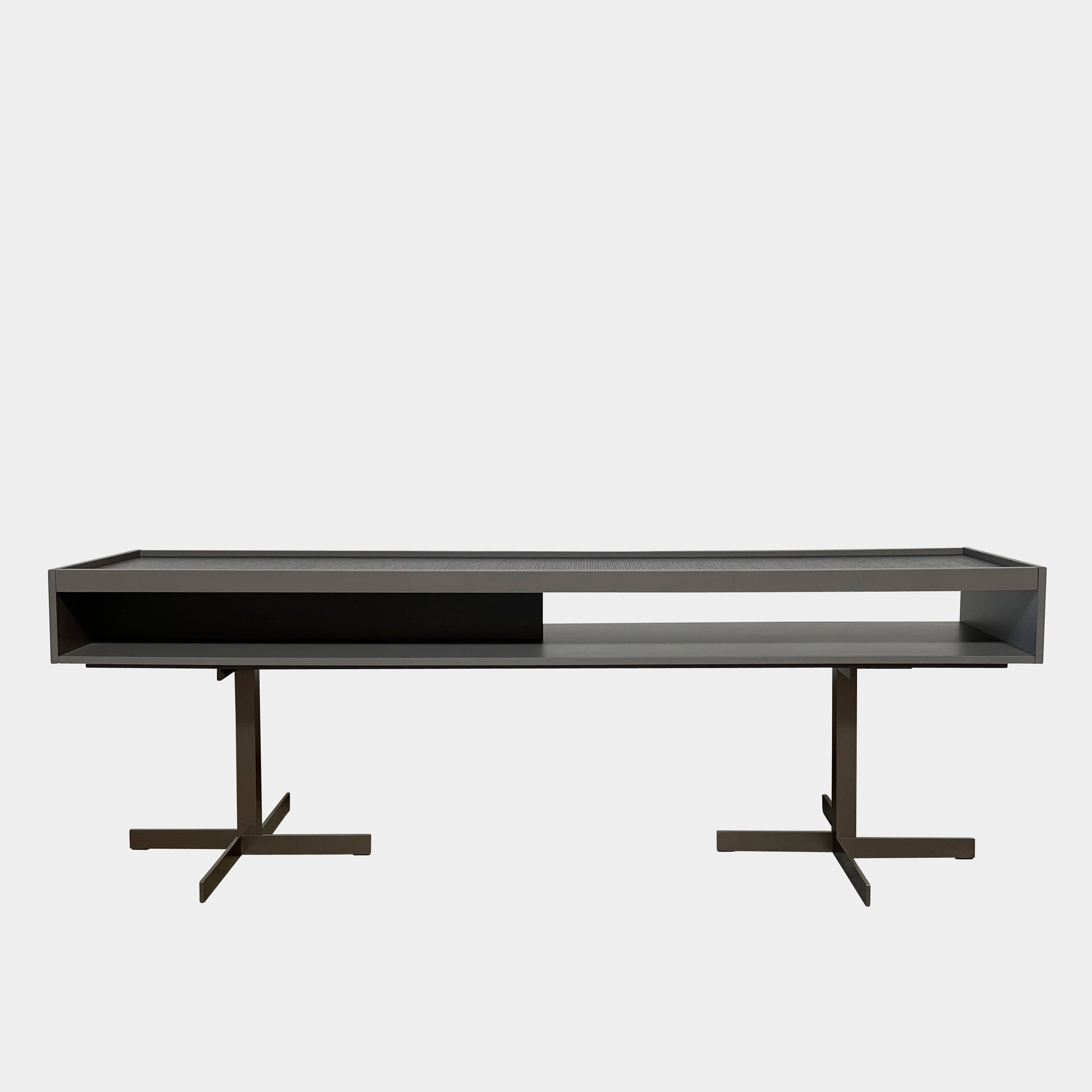 A Minotti Close Console with black legs and a glass top.