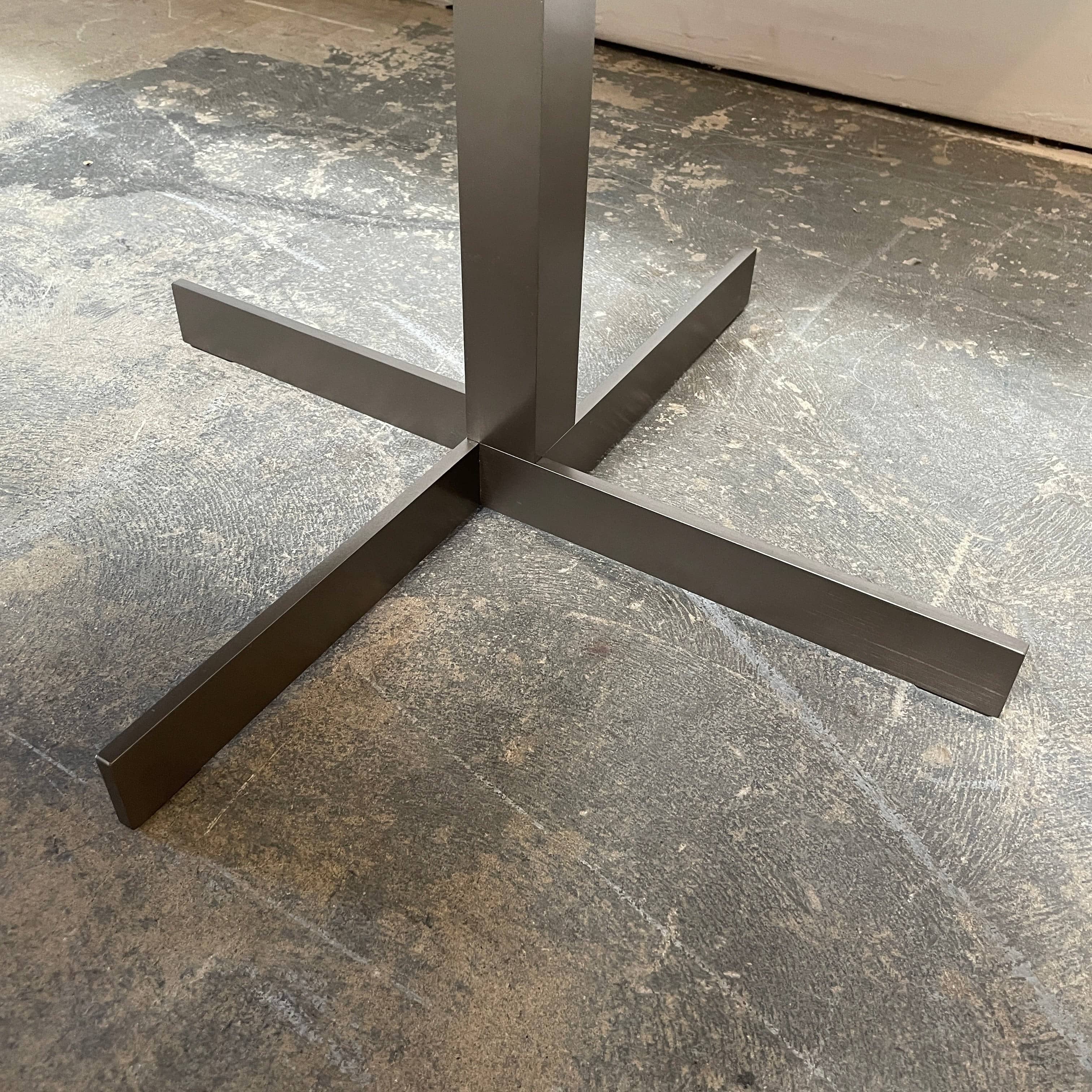 A Minotti Close Console with black legs and a glass top.