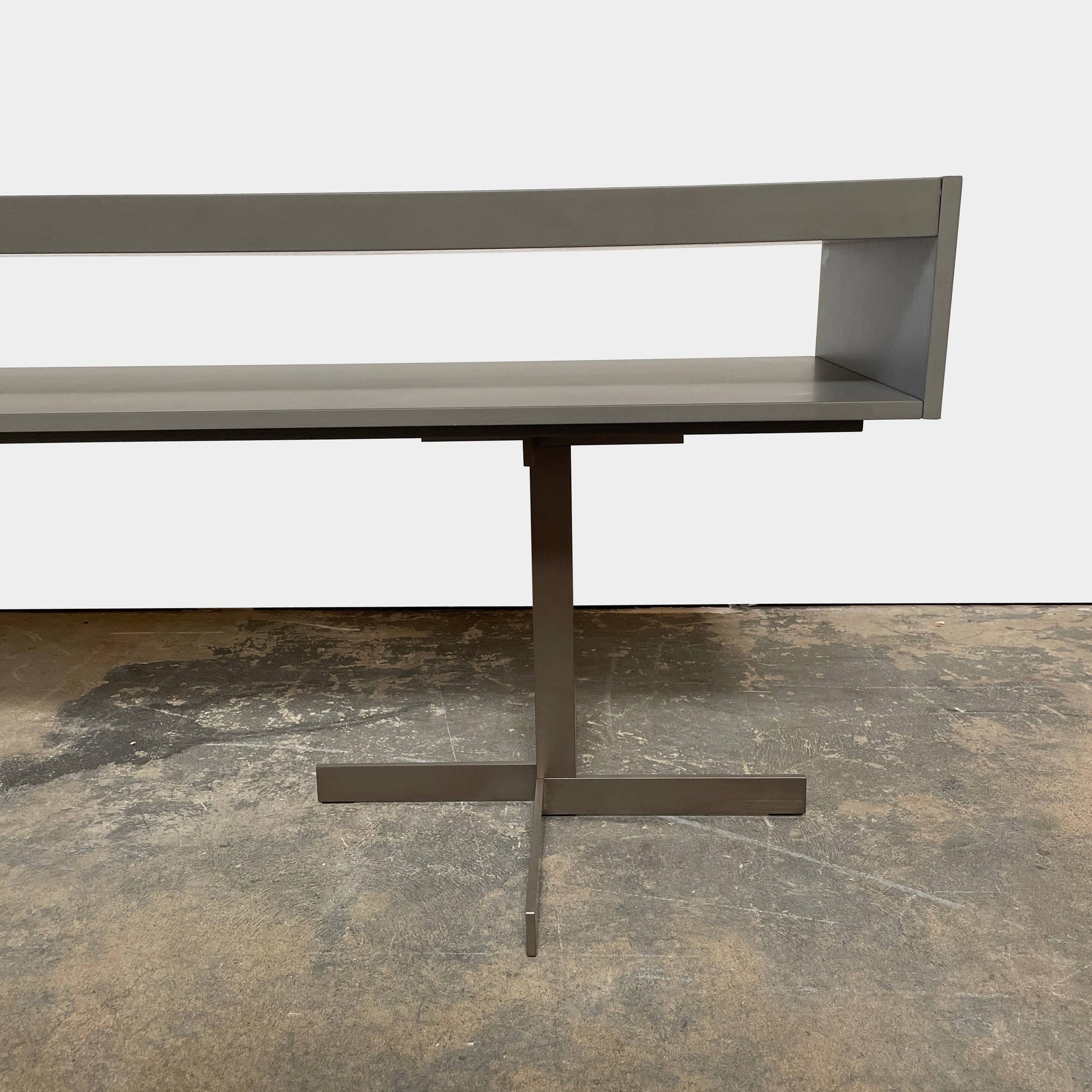 A Minotti Close Console with black legs and a glass top.